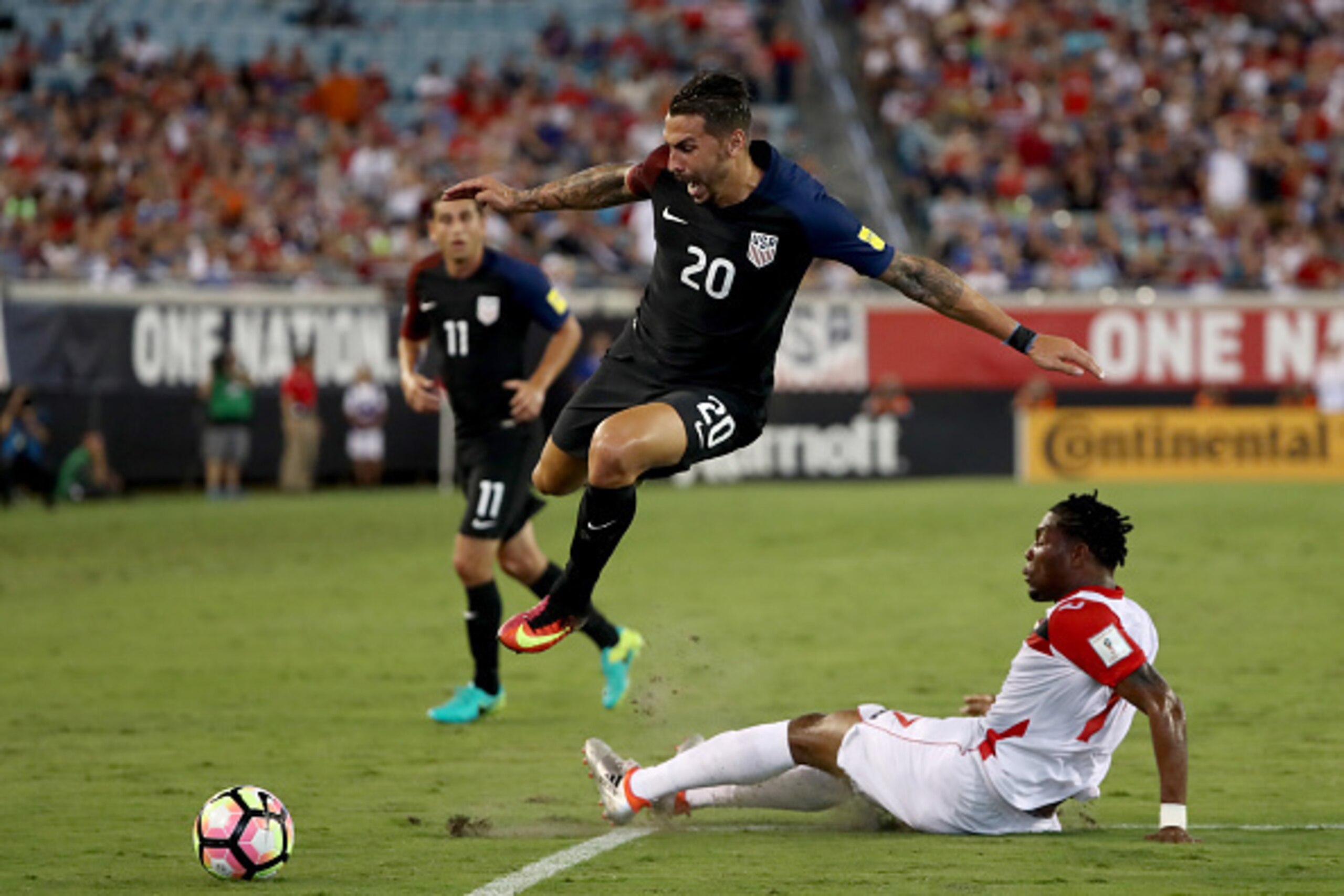 JACKSONVILLE, FL - SEPTEMBER 06:  Geoff Cameron #20 of the United States jumps over Mekeil Williams #17 of Trinidad & Tobago during the FIFA 2018 World Cup Qualifier against Trindad & Tobago at EverBank Field on September 6, 2016 in Jacksonville, Florida.