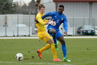 MANZANO, ITALY - FEBRUARY 16:  Bioty Moise Kean (R) of Italy U17 competes with Aleksander Popovic goalkeeper of Serbia U17during the international friendly match between Italy U17 and Serbia U17 at Stadio Comunale  on February 16, 2016 in Manzano, Italy. 