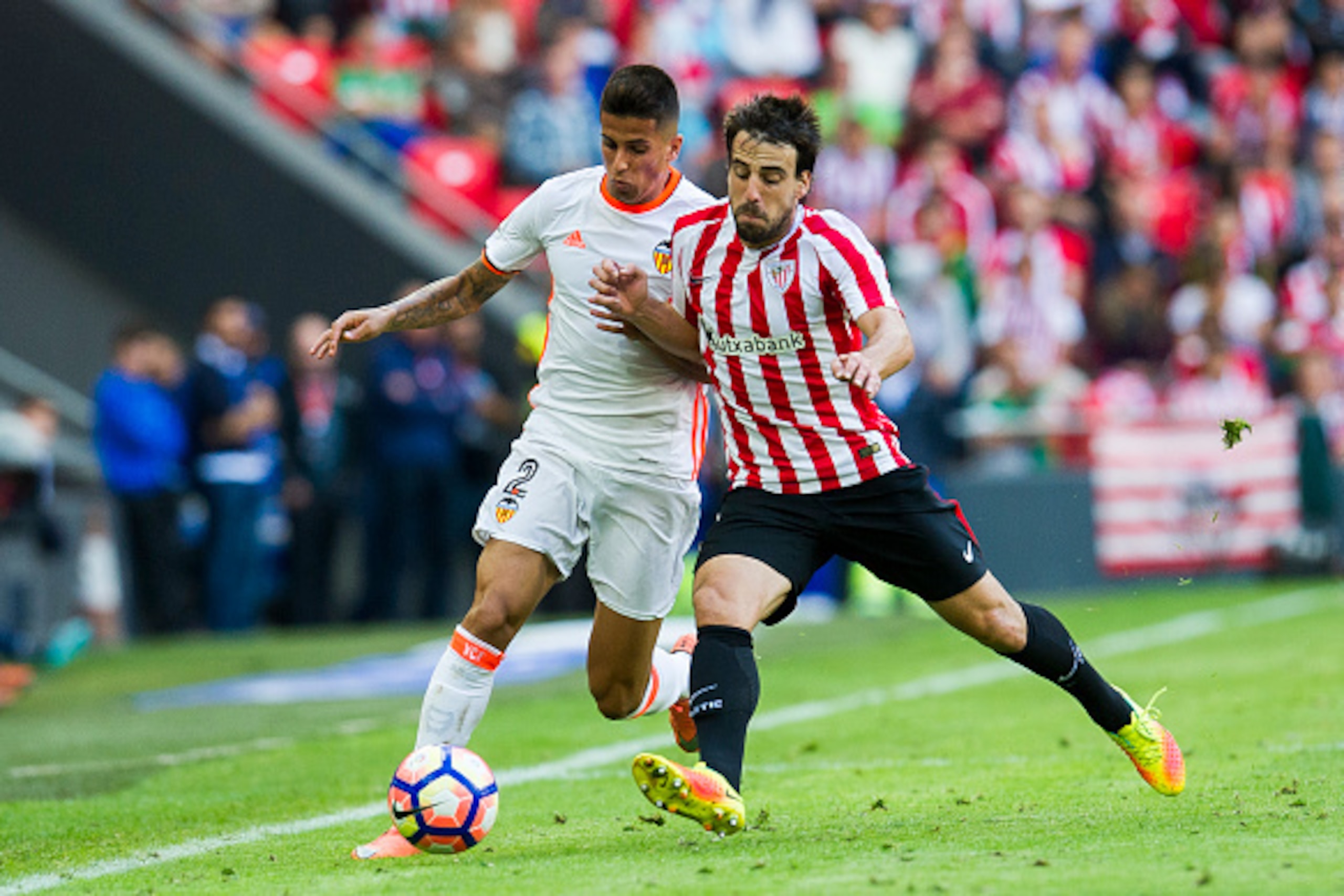 BILBAO, SPAIN - SEPTEMBER 18:  Joao Cancelo of Valencia CF competes for the ball with Benat Etxebarria of Athletic Club  during the La Liga match between Athletic Club Bilbao and Valencia CF at San Mames Stadium on September 18, 2016 in Bilbao, Spain.  (P