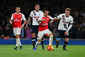 LONDON, ENGLAND - NOVEMBER 08:  Alexis Sanchez of Arsenal and Kyle Walker of Tottenham Hotspur look on as Santi Cazorla of Arsenal battles with Christian Eriksen of Tottenham Hotspur during the Barclays Premier League match between Arsenal and Tottenham H