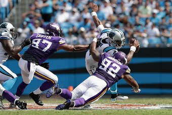 CHARLOTTE, NC - SEPTEMBER 25:   Cam Newton #1 of the Carolina Panthers runs the ball against Everson Griffen #97 and Tom Johnson #92 of the Minnesota Vikings in the 1st half during their game at Bank of America Stadium on September 25, 2016 in Charlotte, 
