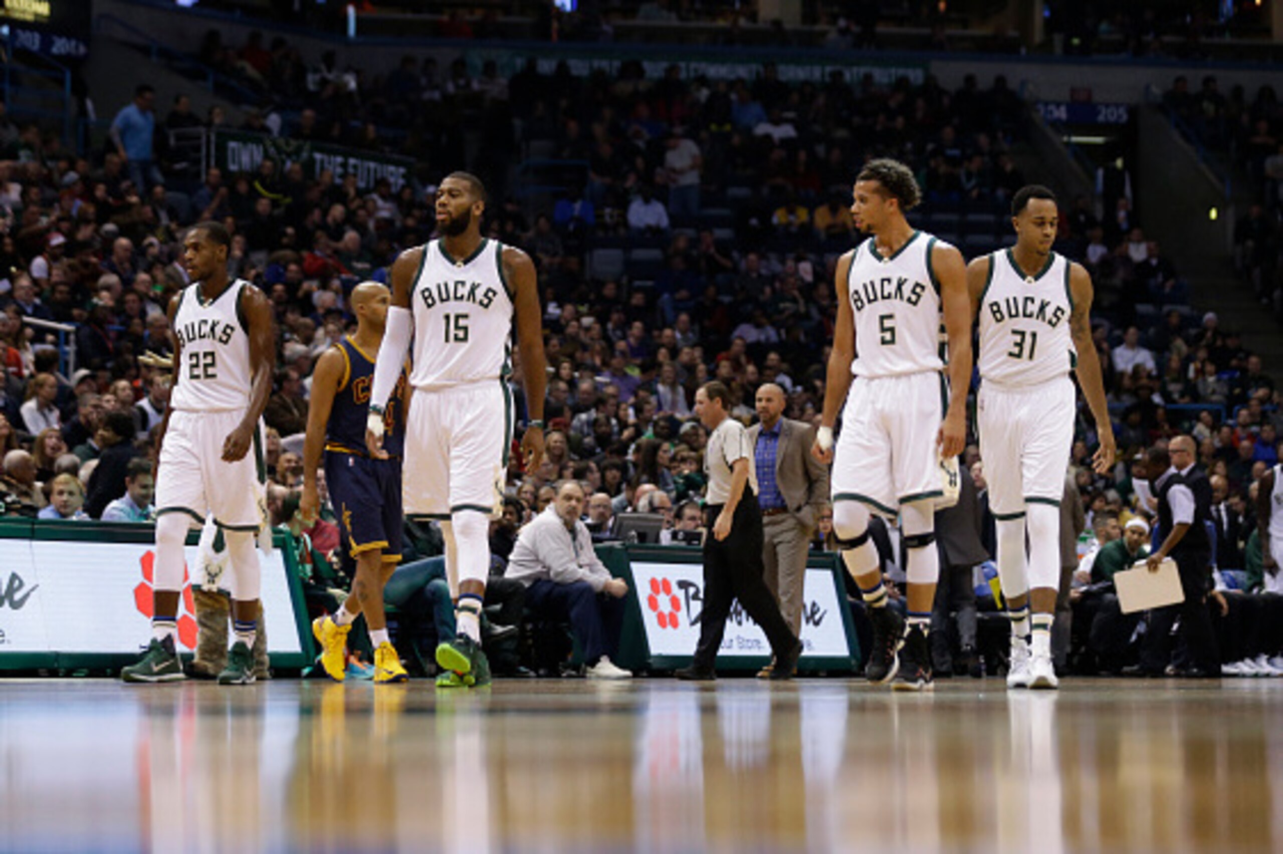 MILWAUKEE, WI - NOVEMBER 14: Greg Monroe #15 of the Milwaukee Bucks along with Michael Carter-Williams #5, Khris Middleton #22 and John Henson #31 walk onto the court during a time out during the game against the Cleveland Cavaliers against the Milwaukee 