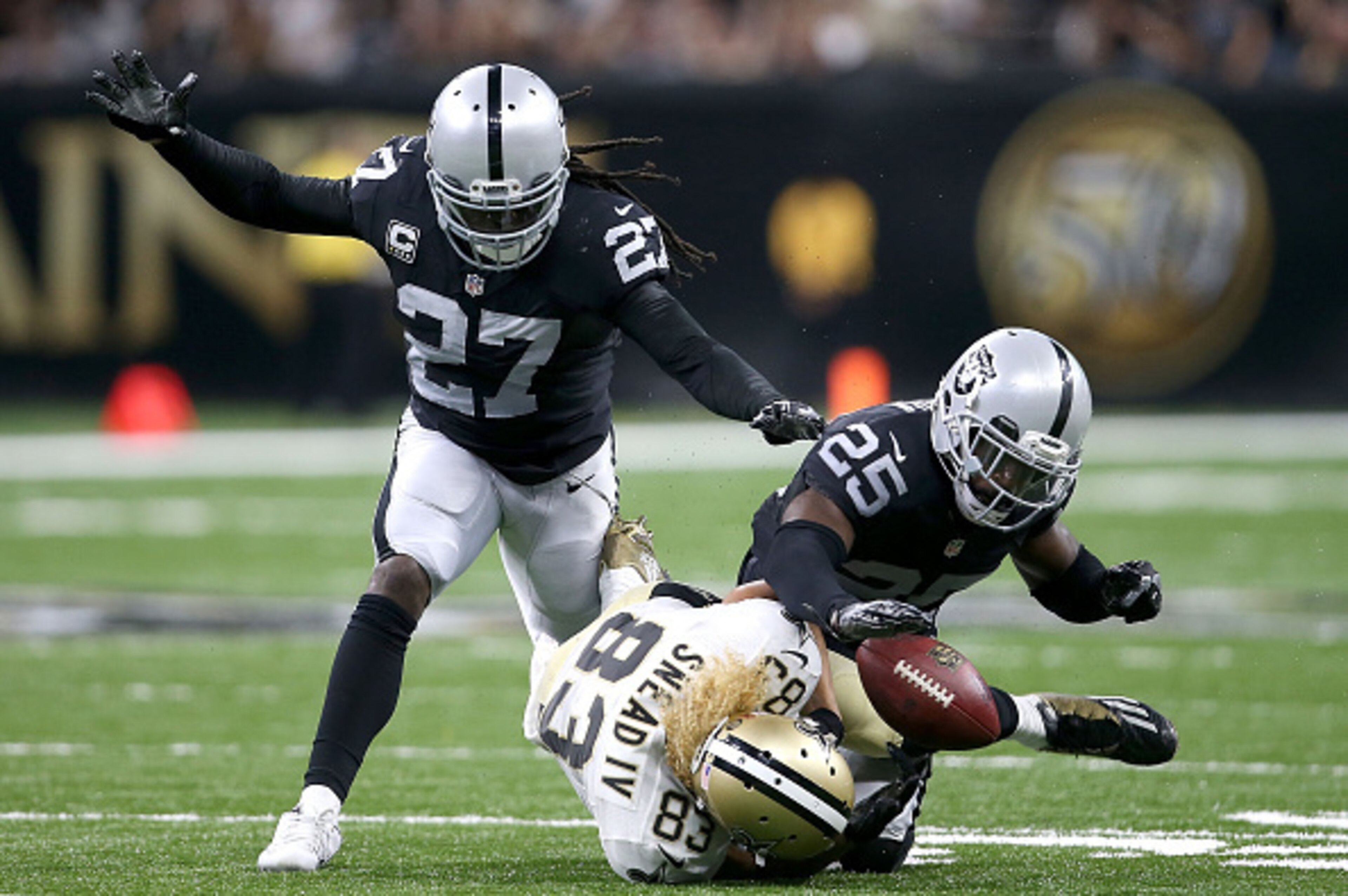NEW ORLEANS, LA - SEPTEMBER 11:  D.J. Hayden #25 of the Oakland Raiders and Reggie Nelson #27 strip the ball from Willie Snead #83 of the New Orleans Saints during the fourth quarter at Mercedes-Benz Superdome on September 11, 2016 in New Orleans, Louisia