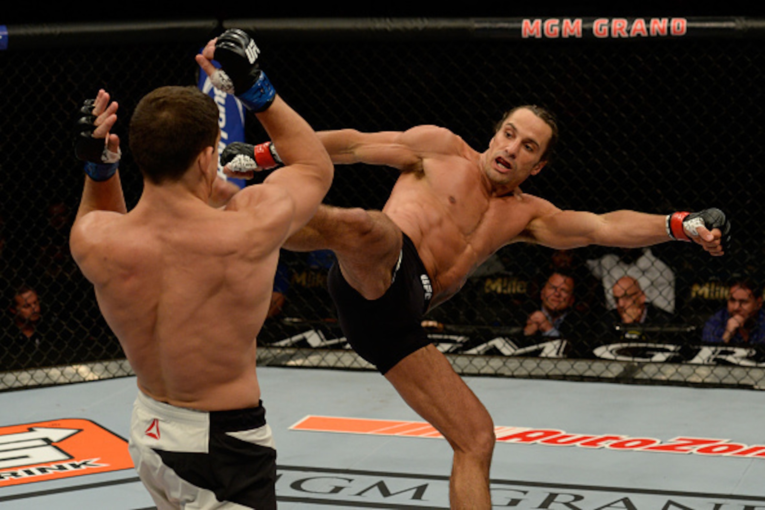 LAS VEGAS, NV - JULY 12:  (R-L) Josh Samman kicks Caio Magalhaes in their middleweight bout during the Ultimate Fighter Finale inside MGM Grand Garden Arena on July 12, 2015 in Las Vegas, Nevada.  (Photo by Brandon Magnus/Zuffa LLC/Zuffa LLC via Getty Ima