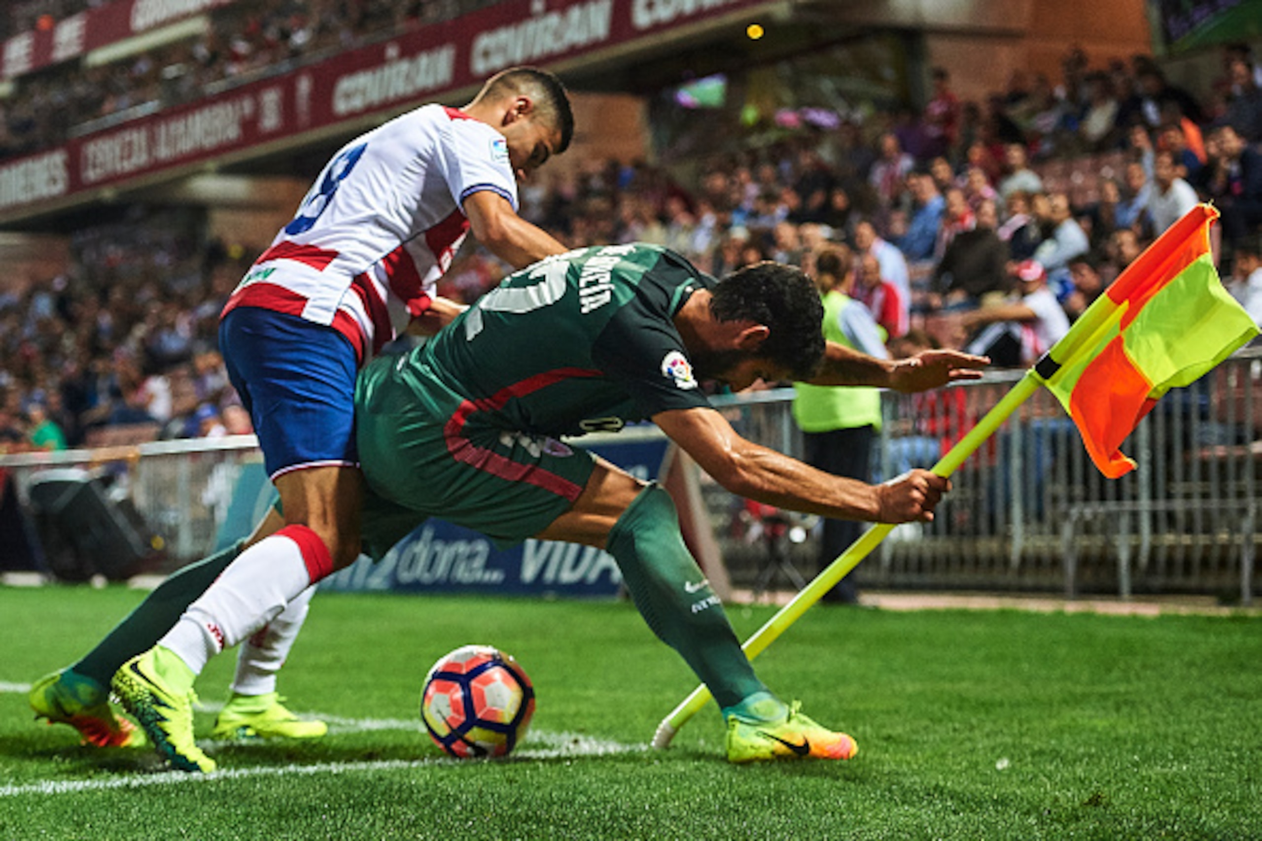 GRANADA, SPAIN - SEPTEMBER 21:  Andreas Pereira of Granada CF (L) competes for the ball with Raul Garcia of Athletic Club (R) during the match between Granada CF vs SD Eibar as part of La Liga at Nuevo los Carmenes Stadium on September 11 on September 21,