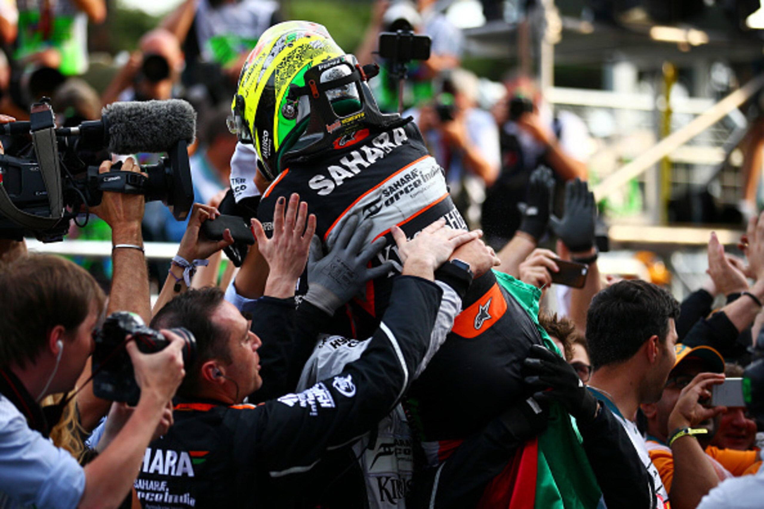 BAKU, AZERBAIJAN - JUNE 19:  Sergio Perez of Mexico and Force India celebrates in parc ferme with his team after finishing third in the European Formula One Grand Prix at Baku City Circuit on June 19, 2016 in Baku, Azerbaijan.  (Photo by Dan Istitene/Gett