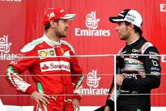 BAKU, AZERBAIJAN - JUNE 19: Sebastian Vettel of Germany and Ferrari and Sergio Perez of Mexico and Force India talk on the podium during the European Formula One Grand Prix at Baku City Circuit on June 19, 2016 in Baku, Azerbaijan.  (Photo by Mark Thompso