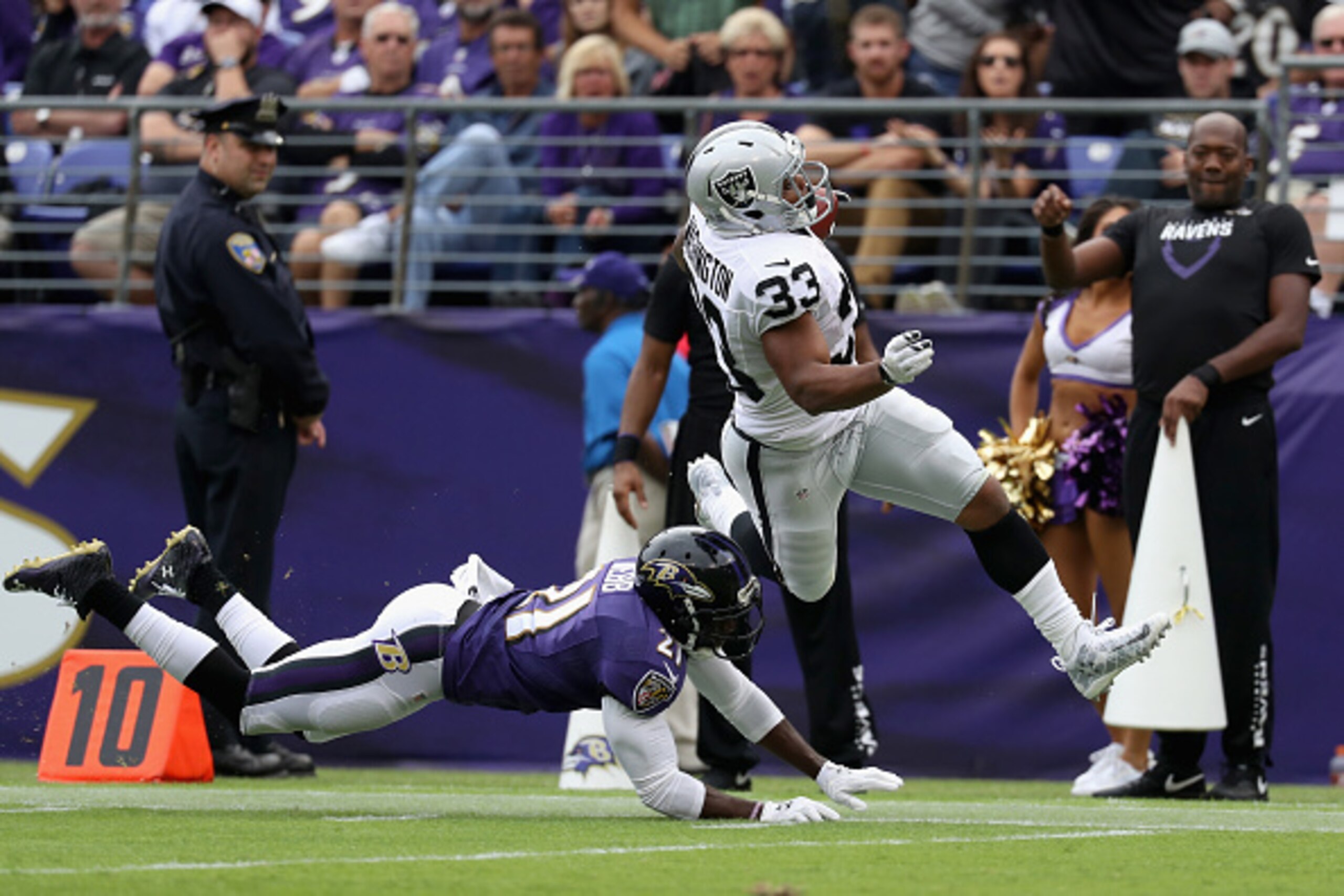 BALTIMORE, MD - OCTOBER 02: Lardarius Webb #21 of the Baltimore Ravens tackles  DeAndre Washington #33 of the Oakland Raiders in the second half at M&T Bank Stadium on October 2, 2016 in Baltimore, Maryland.  (Photo by Rob Carr/Getty Images)