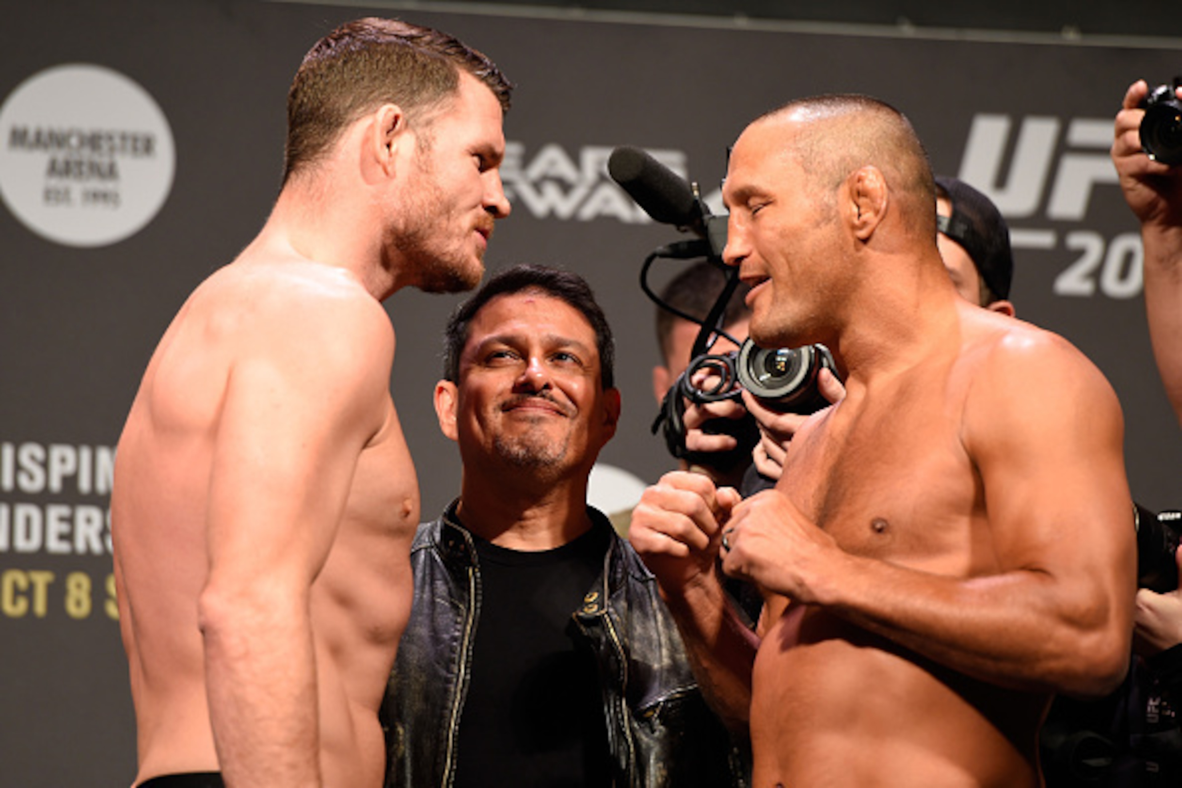 MANCHESTER, ENGLAND - OCTOBER 07:  (L-R) UFC middleweight champion Michael Bisping and Dan Henderson of the United States face-off during the UFC 204 weigh-in at the Manchester Central Convention Complex on October 7, 2016 in Manchester, England. (Photo b
