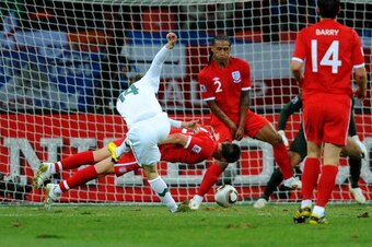 PORT ELIZABETH, SOUTH AFRICA - JUNE 23: John Terry and Glen Johnson of England defend a shot by Zlatko Dedic of Slovenia during the 2010 FIFA World Cup South Africa Group C match between Slovenia and England at the Nelson Mandela Bay Stadium on June 23, 2