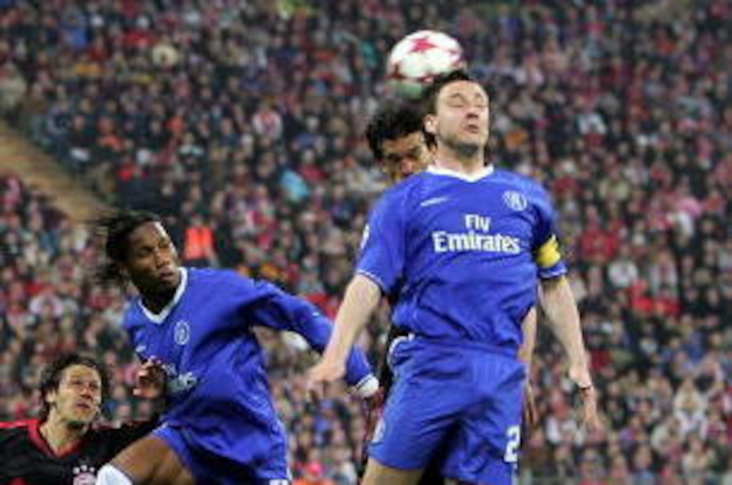 MUNICH, GERMANY - APRIL 12: John Terry of Chelsea challenges in the air with Michael Ballack of Bayern Munich during the UEFA Champions League quarter final second leg match between Bayern Munich and Chelsea at the Olympic Stadium, on April 12, 2005 in Mu