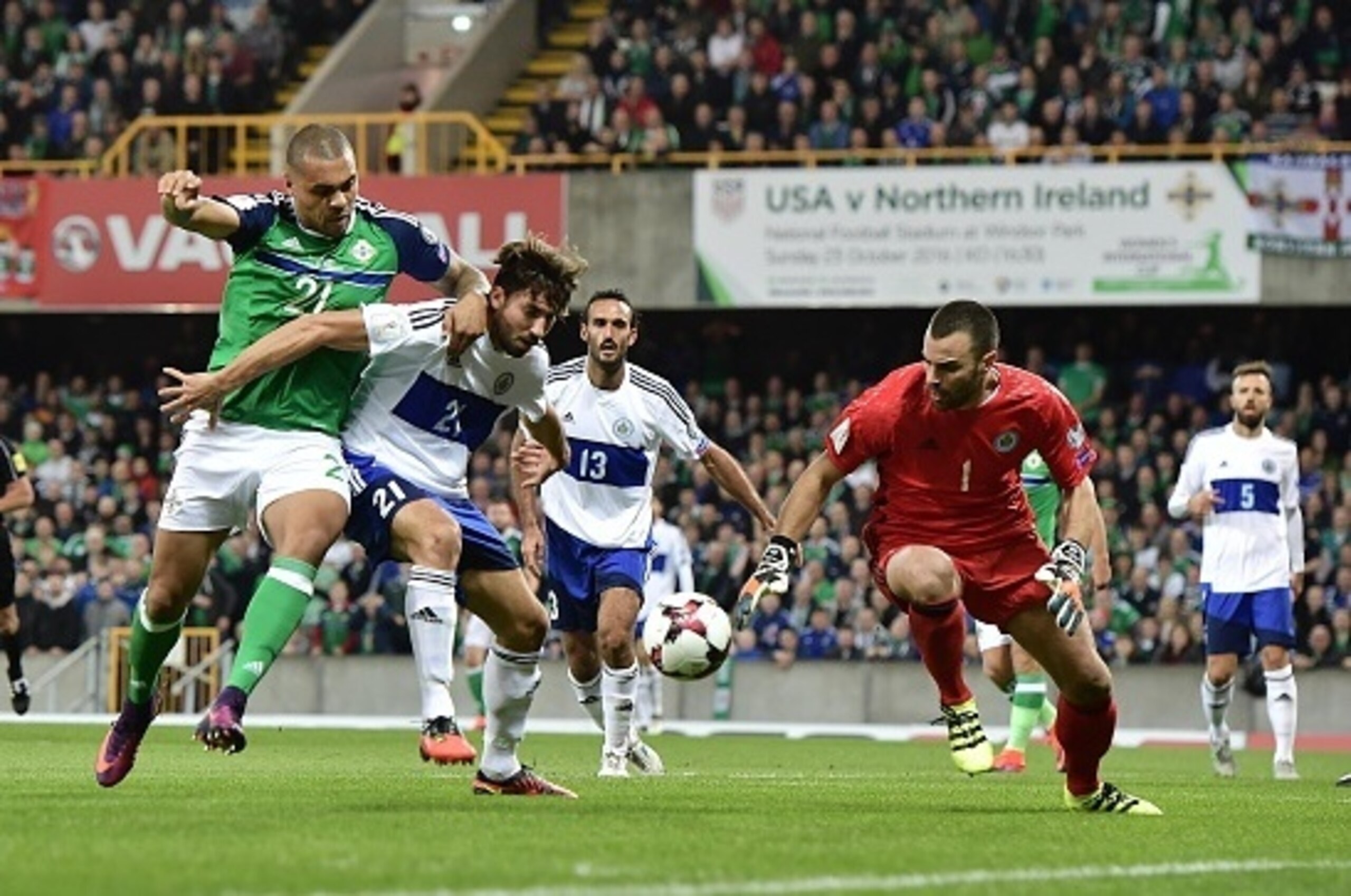 BELFAST, NORTHERN IRELAND - OCTOBER 08: Josh Magennis (L) of Northern Ireland and Aldo Simoncini (R) of San Marino during the FIFA 2018 World Cup Qualifier between Northern Ireland and San Marino at Windsor Park on October 8, 2016 in Belfast, Northern Ire