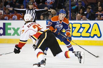 EDMONTON, AB - APRIL 2:  Connor McDavid #97 of the Edmonton Oilers tries to cut past Dougie Hamilton #27 of the Calgary Flames on April 2, 2016 at Rexall Place in Edmonton, Alberta, Canada. (Photo by Codie McLachlan/Getty Images)