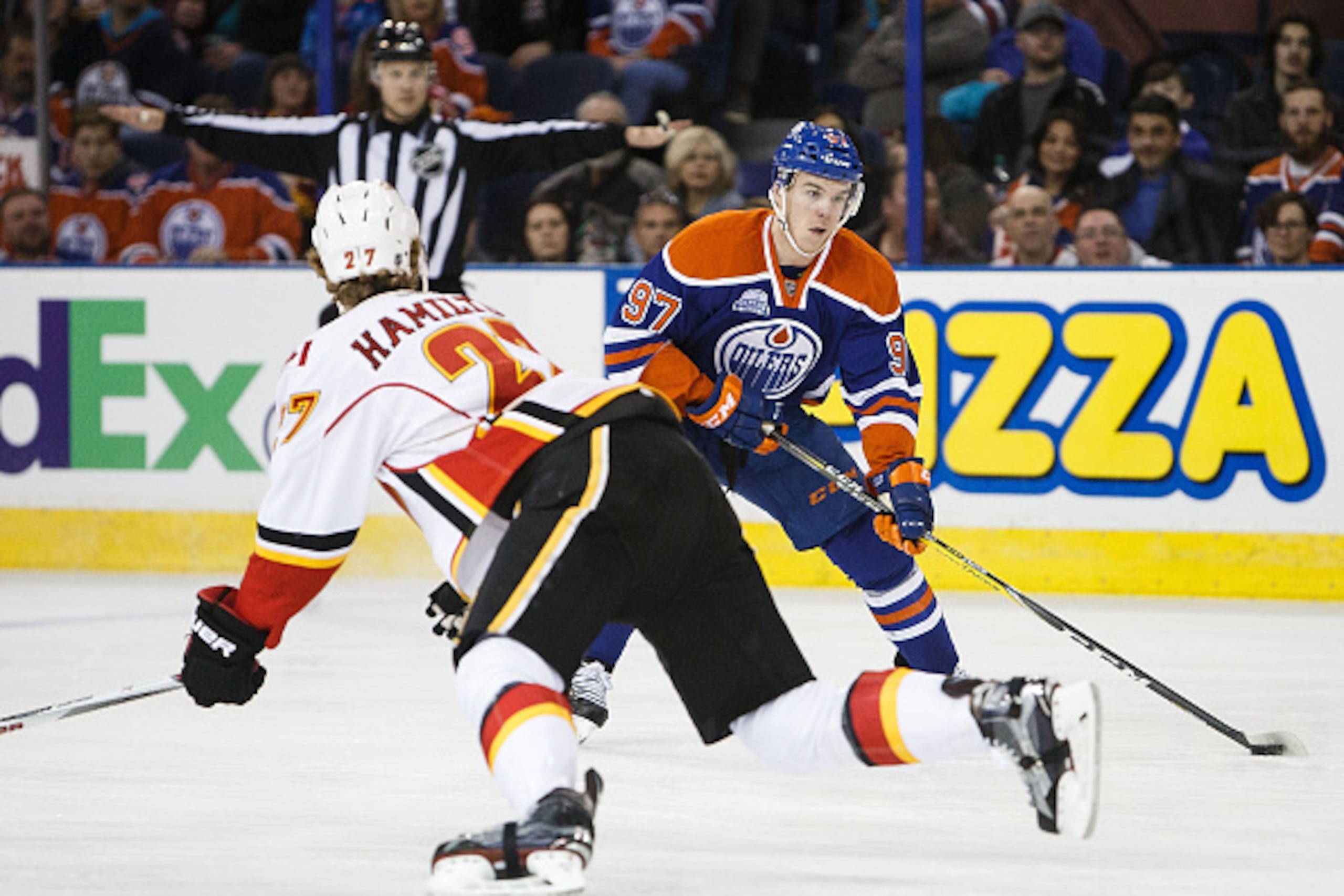 EDMONTON, AB - APRIL 2:  Connor McDavid #97 of the Edmonton Oilers tries to cut past Dougie Hamilton #27 of the Calgary Flames on April 2, 2016 at Rexall Place in Edmonton, Alberta, Canada. (Photo by Codie McLachlan/Getty Images)