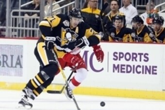 Oct 5, 2016; Pittsburgh, PA, USA;  Pittsburgh Penguins center Evgeni Malkin (71) chases the puck against the Detroit Red Wings during the third period at the PPG Paints Arena. The Red Wings won 5-2. Mandatory Credit: Charles LeClaire-USA TODAY Sports