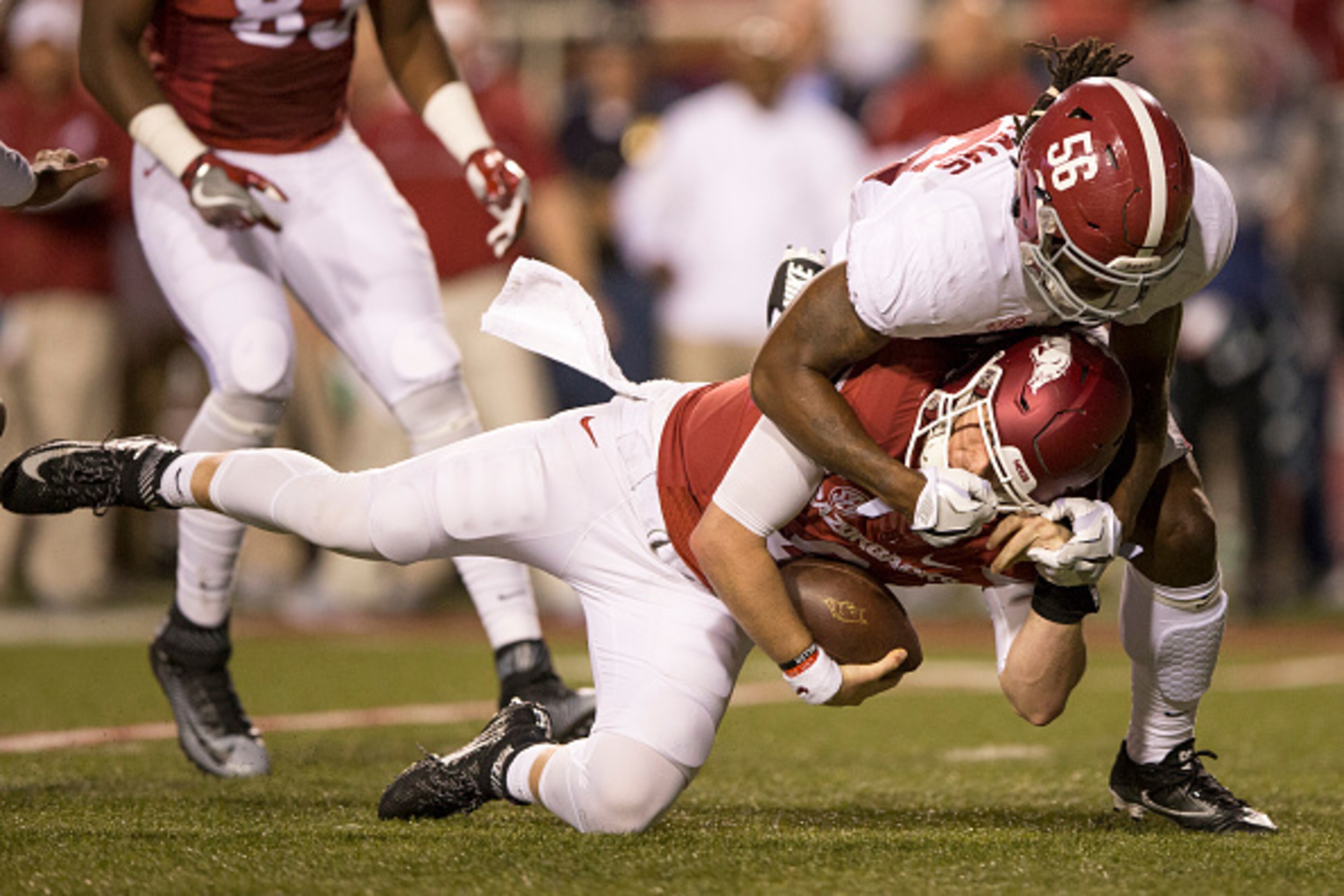 FAYETTEVILLE, AR - OCTOBER 8:  Austin Allen #8 of the Arkansas Razorbacks is sacked by Brandon Kennedy #56 of the Alabama Crimson Tide at Razorback Stadium on October 8, 2016 in Fayetteville, Arkansas.  (Photo by Wesley Hitt/Getty Images)