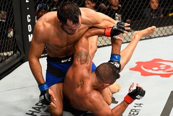 MANCHESTER, ENGLAND - OCTOBER 08:  Gegard Mousasi of The Netherlands (top) punches Vitor Belfort of Brazil in their middleweight bout during the UFC 204 Fight Night at the Manchester Evening News Arena on October 8, 2016 in Manchester, England. (Photo by 