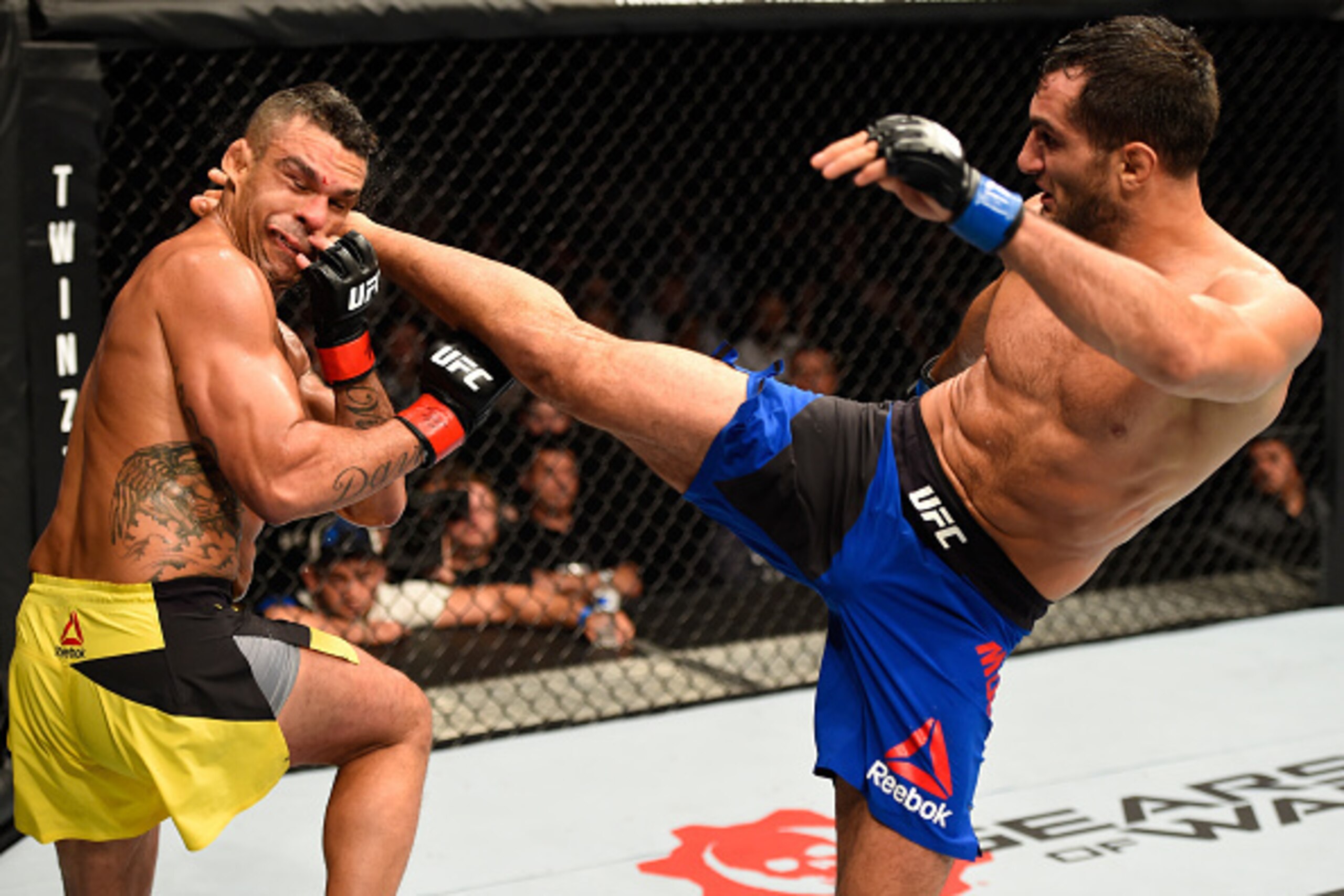MANCHESTER, ENGLAND - OCTOBER 08:  (R-L) Gegard Mousasi of The Netherlands kicks Vitor Belfort of Brazil in their middleweight bout during the UFC 204 Fight Night at the Manchester Evening News Arena on October 8, 2016 in Manchester, England. (Photo by Jo