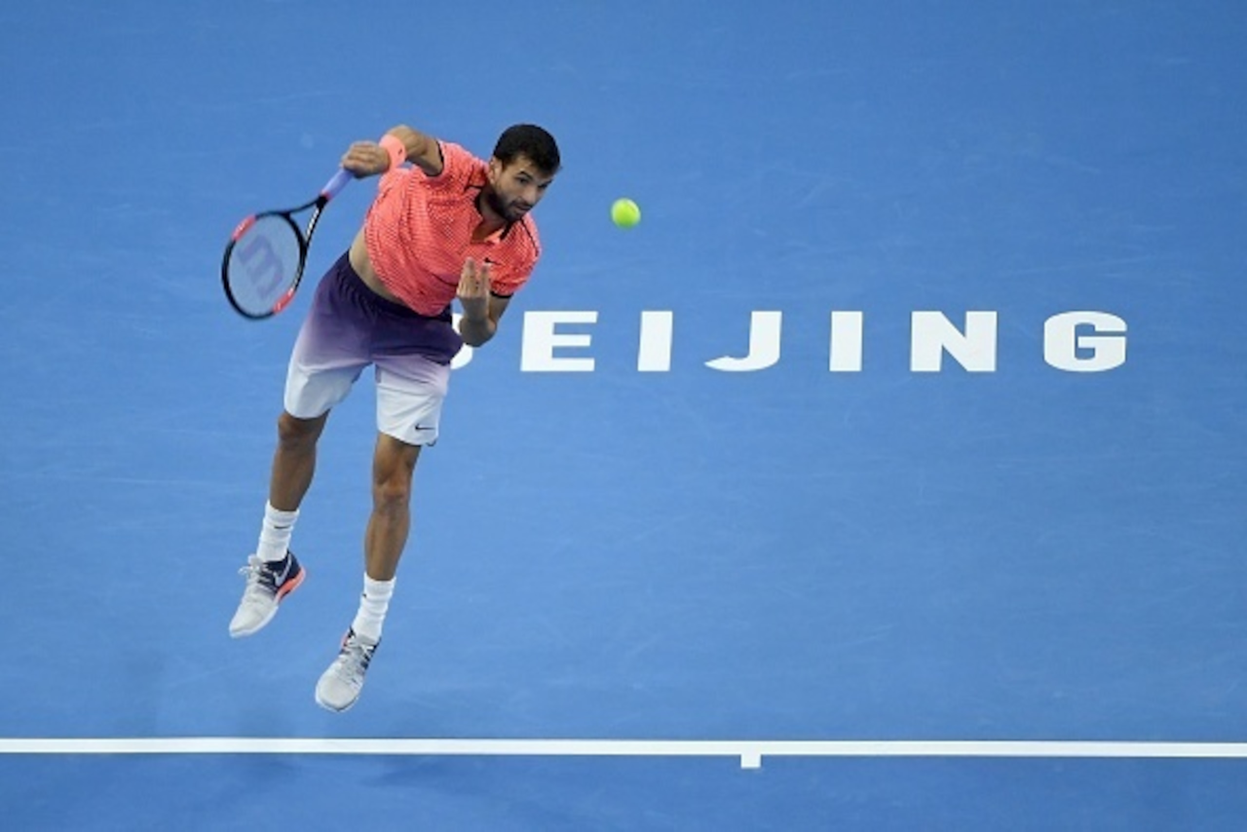 Grigor Dimitrov of Bulgaria serves against Andy Murray of Britain during the men's singles final at the China Open tennis tournament in Beijing on October 9, 2016. / AFP / WANG ZHAO        (Photo credit should read WANG ZHAO/AFP/Getty Images)