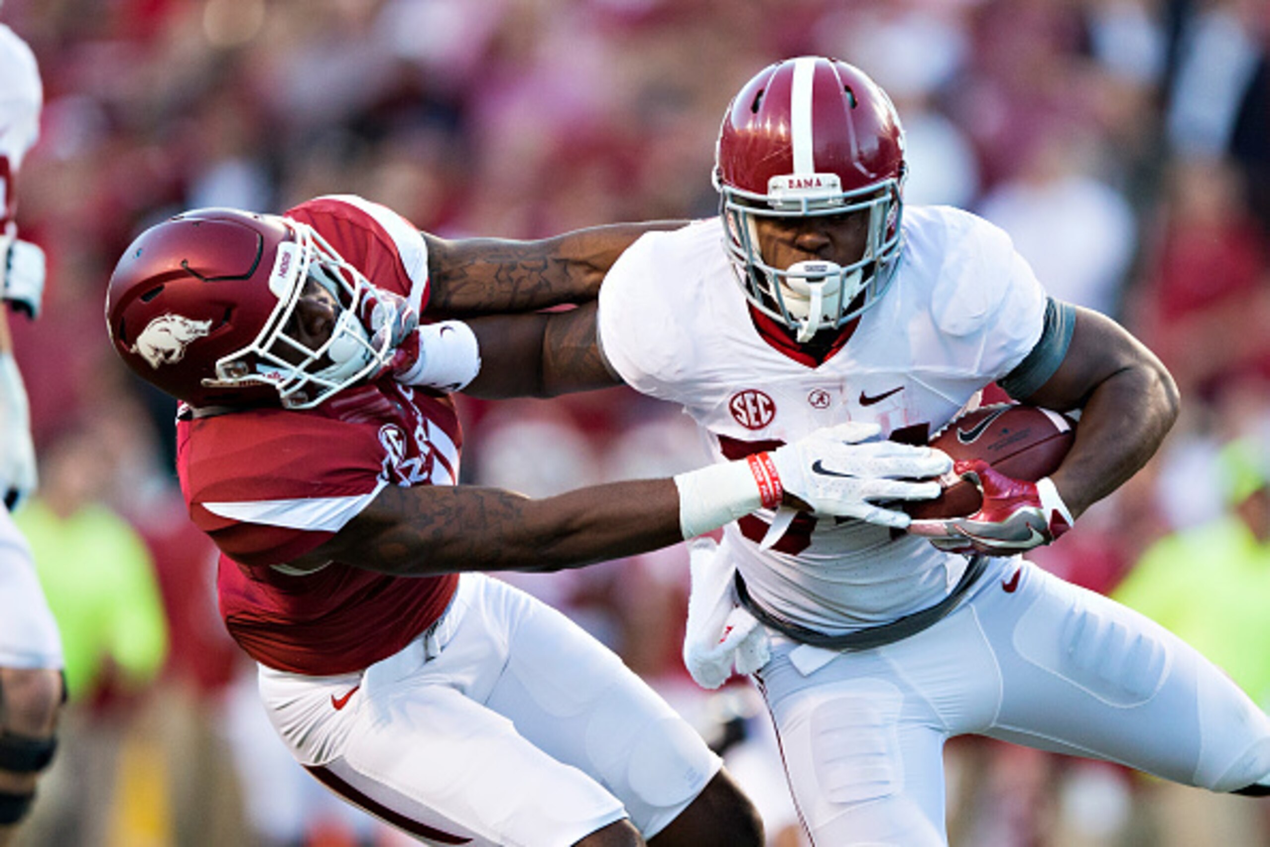 FAYETTEVILLE, AR - OCTOBER 8:  Damian Harris #34 of the Alabama Crimson Tide runs for a touchdown and stiff arms Ryan Pulley #11 of the Arkansas Razorbacks at Razorback Stadium on October 8, 2016 in Fayetteville, Arkansas.  (Photo by Wesley Hitt/Getty Ima