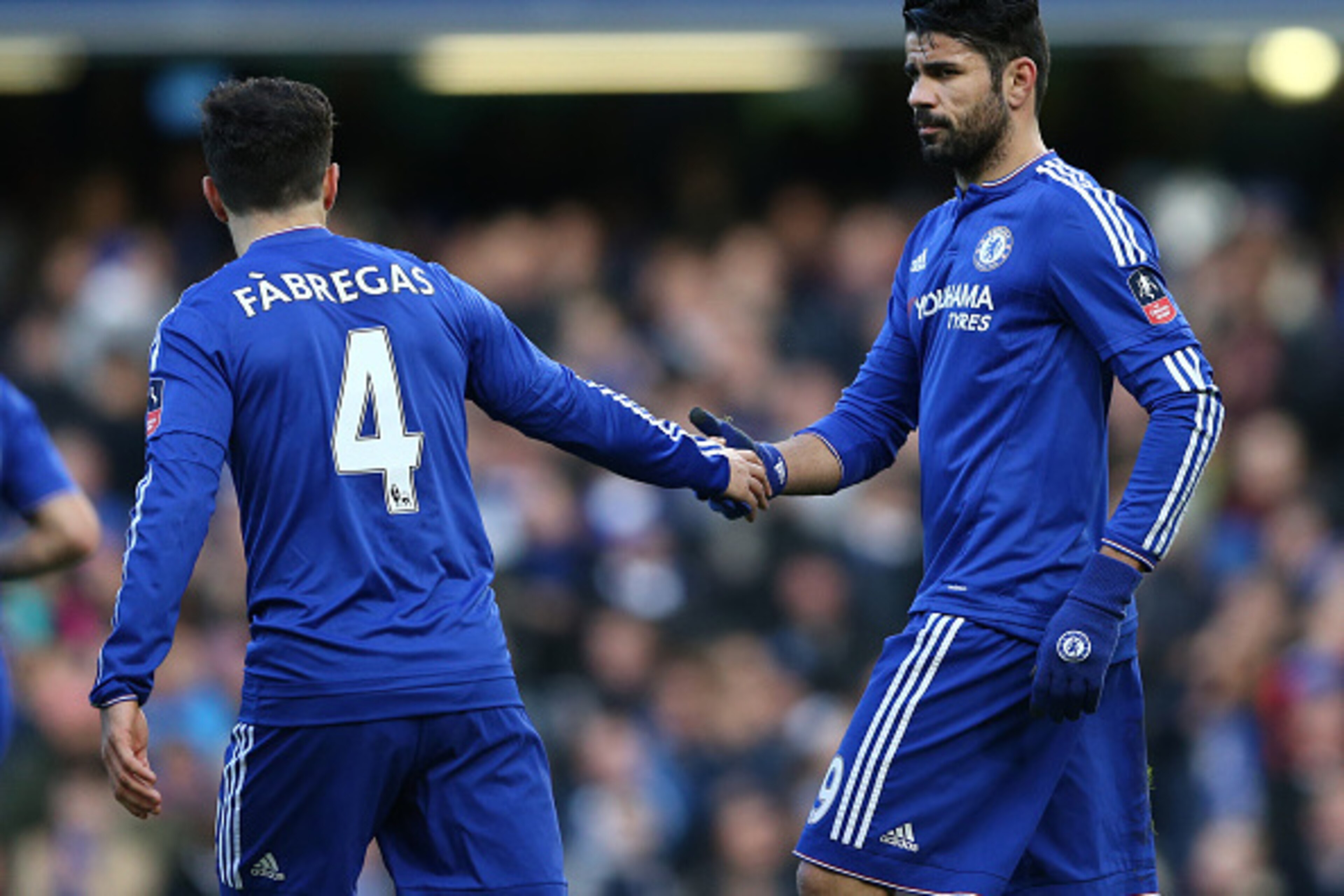 Chelsea's Brazilian-born Spanish striker Diego Costa (R) celebrates with Chelsea's Spanish midfielder Cesc Fabregas after scoring his team's first goal during the FA Cup third-round football match between Chelsea and Scunthorpe United at Stamford Bridge i