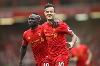 LIVERPOOL, ENGLAND - SEPTEMBER 24:  Philippe Coutinho of Liverpool celebrates with Sadio Mane as he scores their fourth goal during the Premier League match between Liverpool and Hull City at Anfield on September 24, 2016 in Liverpool, England.  (Photo by