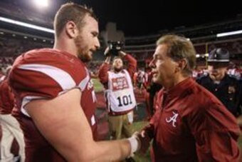 Oct 8, 2016; Fayetteville, AR, USA; Alabama Crimson Tide head coach Nick Saban offers his condolences to Arkansas Razorbacks center Frank Ragnow (72) for the loss Ragnow's father after the game at Donald W. Reynolds Razorback Stadium. Alabama defeated Ark