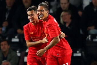 DERBY, ENGLAND - SEPTEMBER 20:  Philippe Coutinho (L) of Liverpool celebrates scoring his team's second goal with Roberto Firmino during the EFL Cup Third Round match between Derby County and Liverpool at iPro Stadium on September 20, 2016 in Derby, Engla