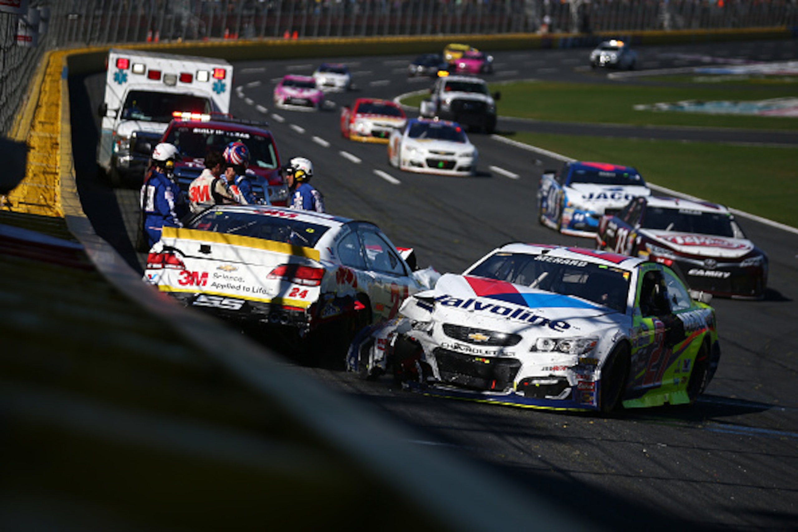 CHARLOTTE, NC - OCTOBER 09:  Chase Elliott, driver of the #24 3M Chevrolet, and Paul Menard, driver of the #27 Valvoline/Menards Chevrolet, spin during the NASCAR Sprint Cup Series Bank of America 500 at Charlotte Motor Speedway on October 9, 2016 in Char
