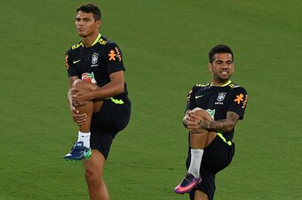 Brazil's football team players Thiago Silva (L) and Daniel Alves take part in a training session at the Arena Dunas stadium in Natal, Brazil, on October 4, 2016 ahead of their Russia 2018 FIFA World Cup qualifier matches against Bolivia and Venezuela. / A