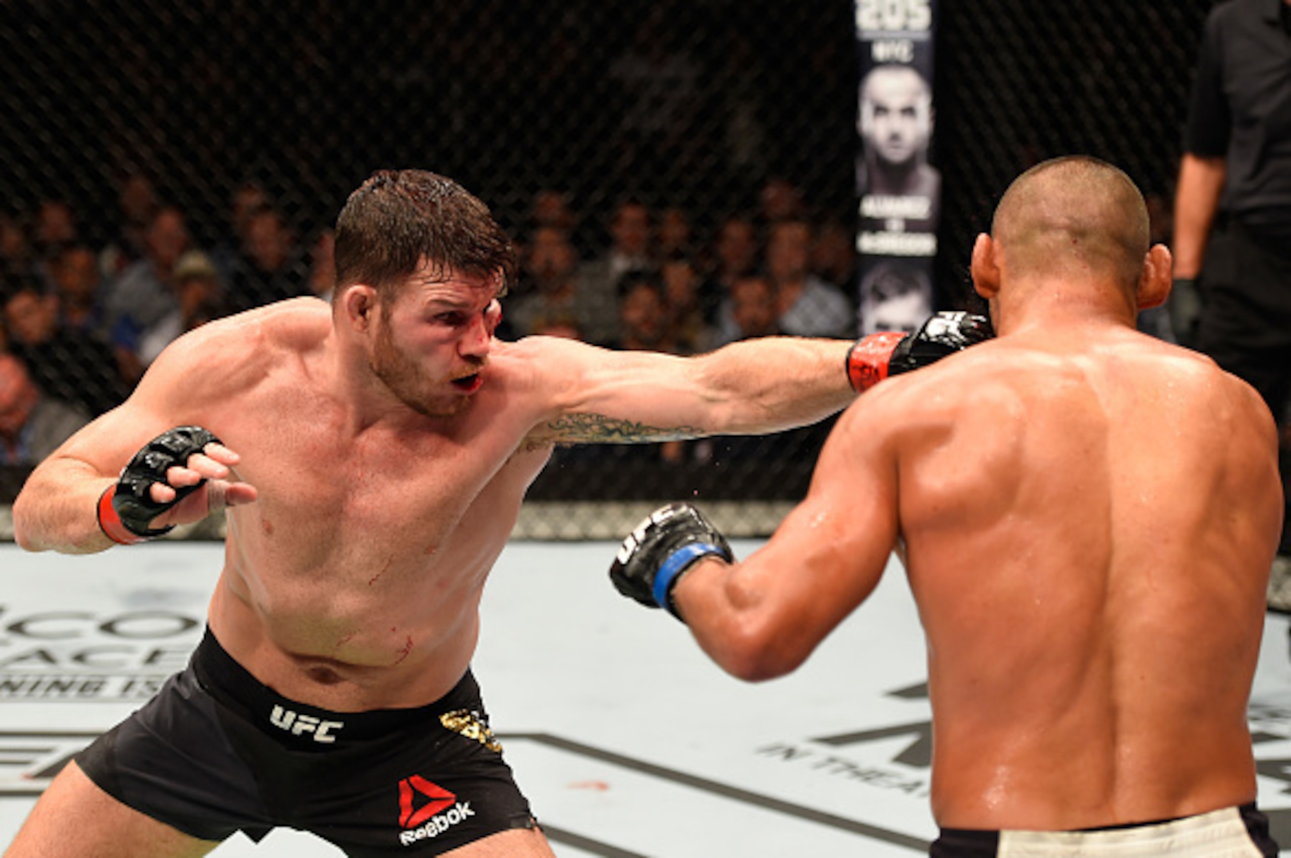 MANCHESTER, ENGLAND - OCTOBER 08:  (L-R) Michael Bisping of England punches Dan Henderson in their UFC middleweight championship bout during the UFC 204 Fight Night at the Manchester Evening News Arena on October 8, 2016 in Manchester, England. (Photo by 