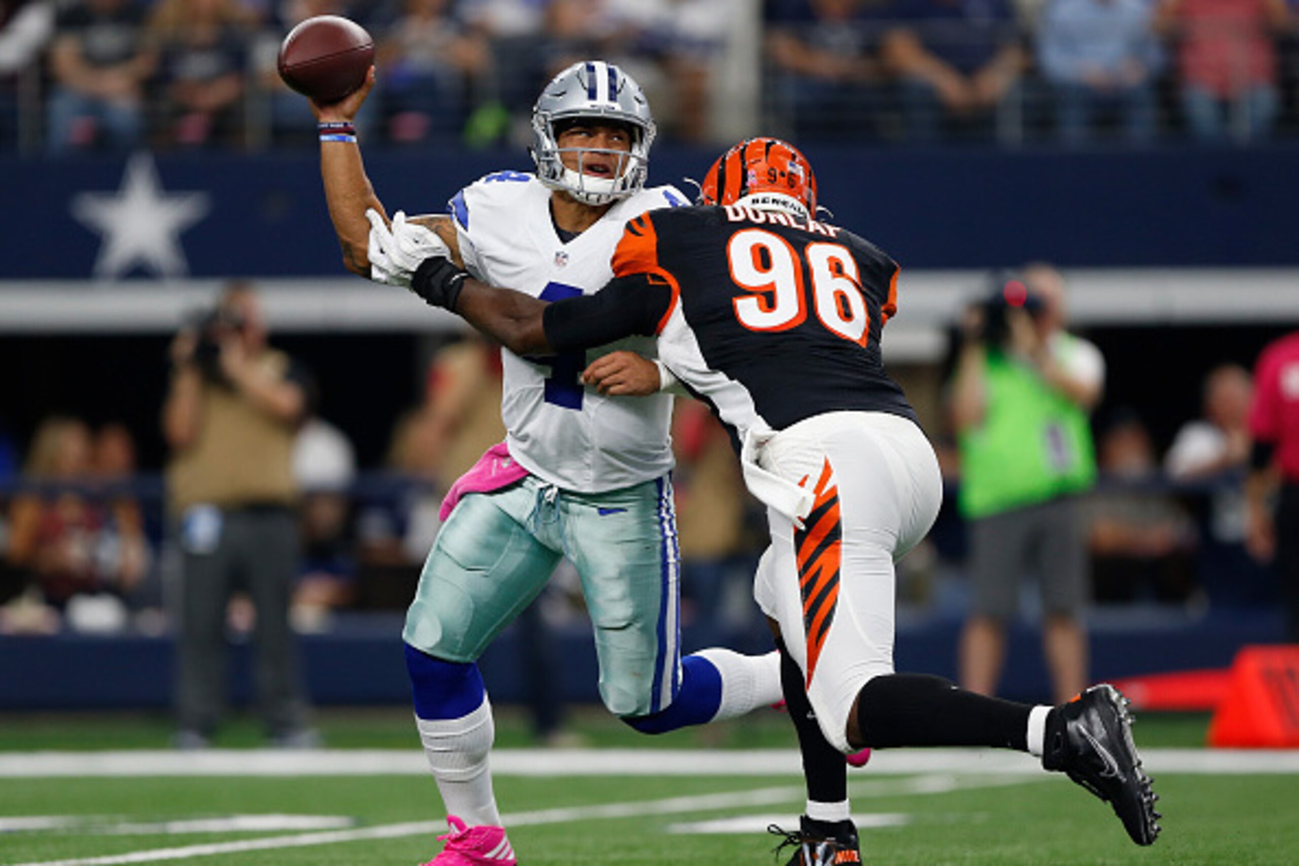 ARLINGTON, TX - OCTOBER 09:   Dak Prescott #4 of the Dallas Cowboys is pressured by Carlos Dunlap #96 of the Cincinnati Bengals during the second quarter at AT&T Stadium on October 9, 2016 in Arlington, Texas. (Photo by Wesley Hitt/Getty Images)