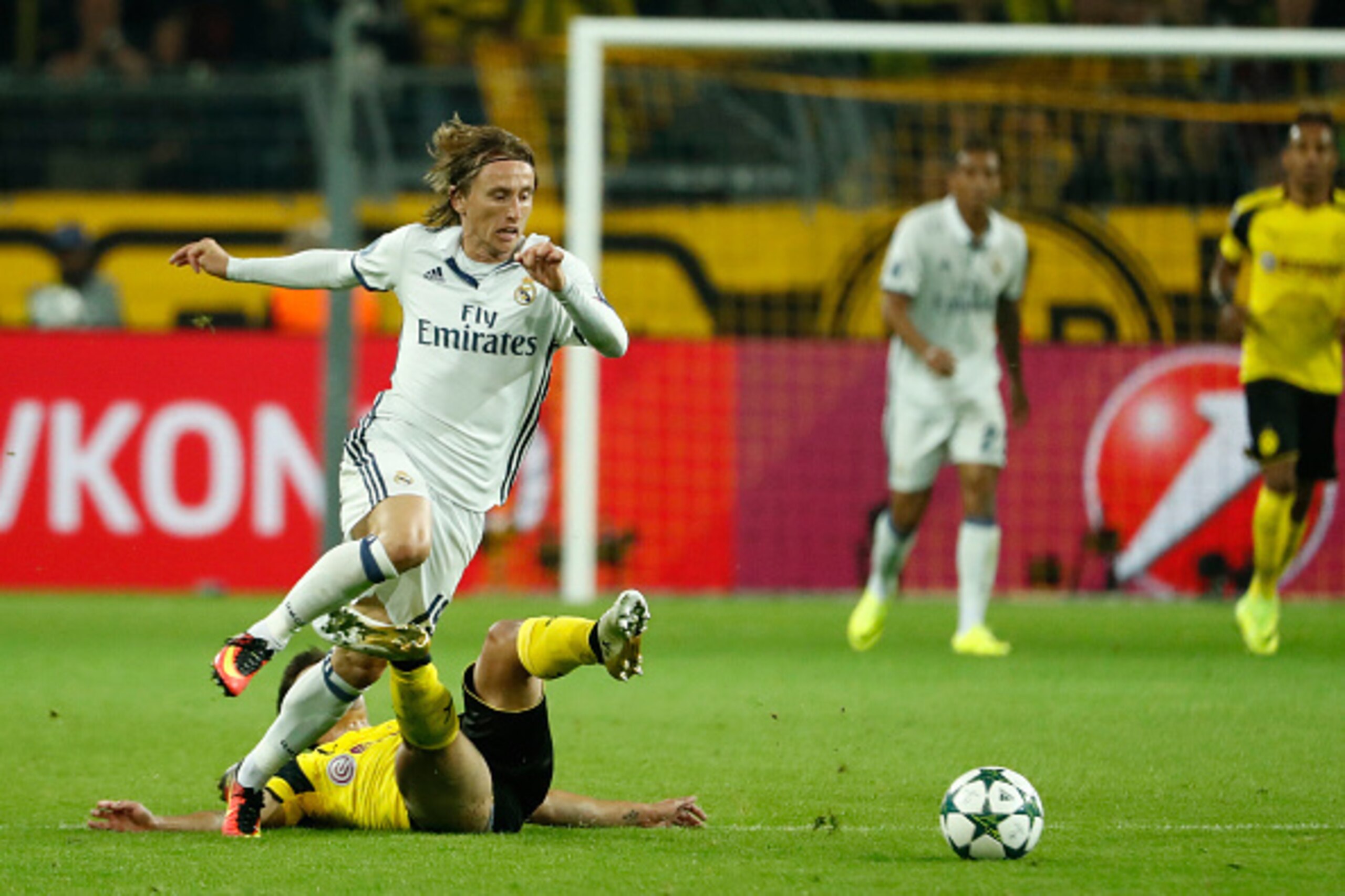 Dortmund's midfielder Julian Weigl (down) fouls Real Madrid's Croatian midfielder Luka Modric during the UEFA Champions League first leg football match between Borussia Dortmund and Real Madrid at BVB stadium in Dortmund, on September 27, 2016. / AFP / Od Dortmund's midfielder Julian Weigl (down) fouls Real Madrid's Croatian midfielder Luka Modric during the UEFA Champions League first leg football match between Borussia Dortmund and Real Madrid at BVB stadium in Dortmund, on September 27, 2016. / AFP / Od