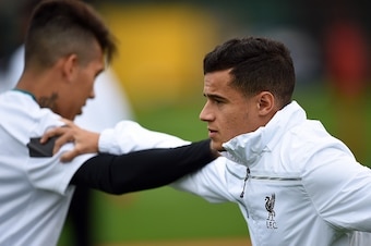 Liverpool's Brazilian midfielder Philippe Coutinho (R) stretches with Brazilian midfielder Roberto Firmino during a team training session in Liverpool, northwest England, on October 21, 2015, on the eve of their UEFA Europa League group B football match a