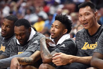 ANAHEIM, CA - OCTOBER 04:  Brandon Ingram #14 and Yi Jianlian #11 of the Los Angeles Lakers laugh on the bench during a preseason game against the Sacramento Kings at Honda Center on October 4, 2016 in Anaheim, California.  NOTE TO USER: User expressly ac