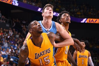 Ontario, CA - OCTOBER 9:  Thomas Robinson #15 and Nick Young #0 of the Los Angeles Lakers box out Juancho Hernangomez #41 of the Denver Nuggets during a preseason game on October 9, 2016 at Citizens Business Bank Arena in Ontario, California. NOTE TO USER