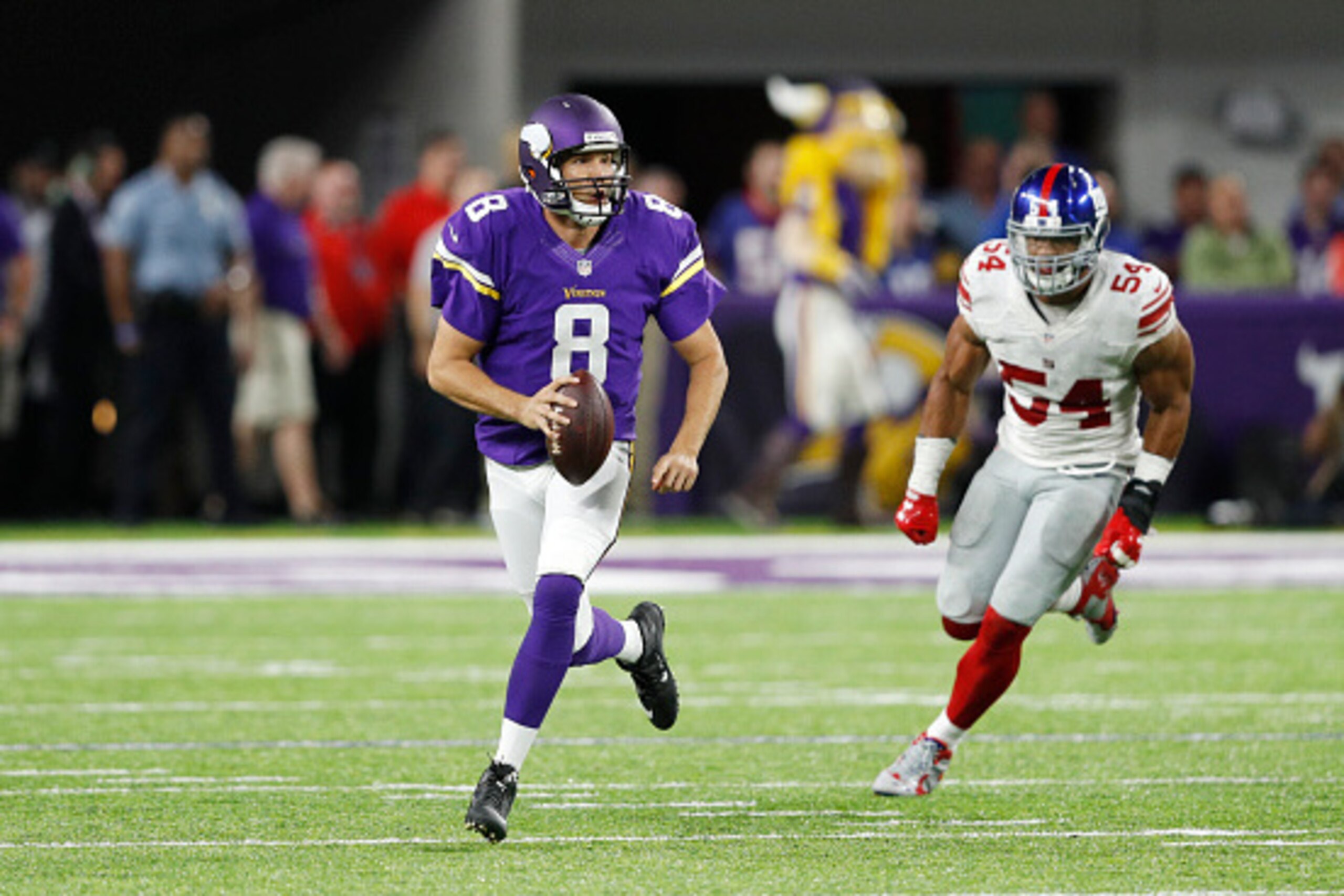 MINNEAPOLIS, MN - OCTOBER 03: Sam Bradford #8 of the Minnesota Vikings looks to pass while being chased by Olivier Vernon #54 of the New York Giants during the game at U.S. Bank Stadium on October 3, 2016 in Minneapolis, Minnesota. The Vikings defeated th