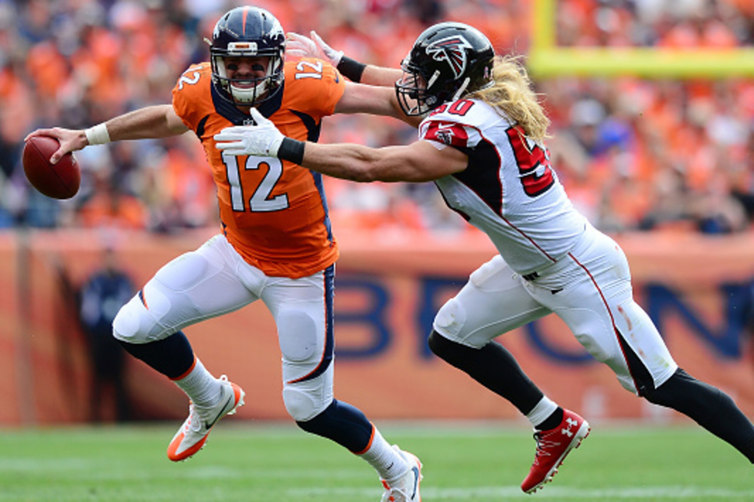 DENVER, CO - OCTOBER 9: Quarterback Paxton Lynch #12 of the Denver Broncos stiff arms linebacker A.J. Hawk #50 of the Atlanta Falcons in the first half of the game at Sports Authority Field at Mile High on October 9, 2016 in Denver, Colorado. (Photo by D DENVER, CO - OCTOBER 9: Quarterback Paxton Lynch #12 of the Denver Broncos stiff arms linebacker A.J. Hawk #50 of the Atlanta Falcons in the first half of the game at Sports Authority Field at Mile High on October 9, 2016 in Denver, Colorado. (Photo by D