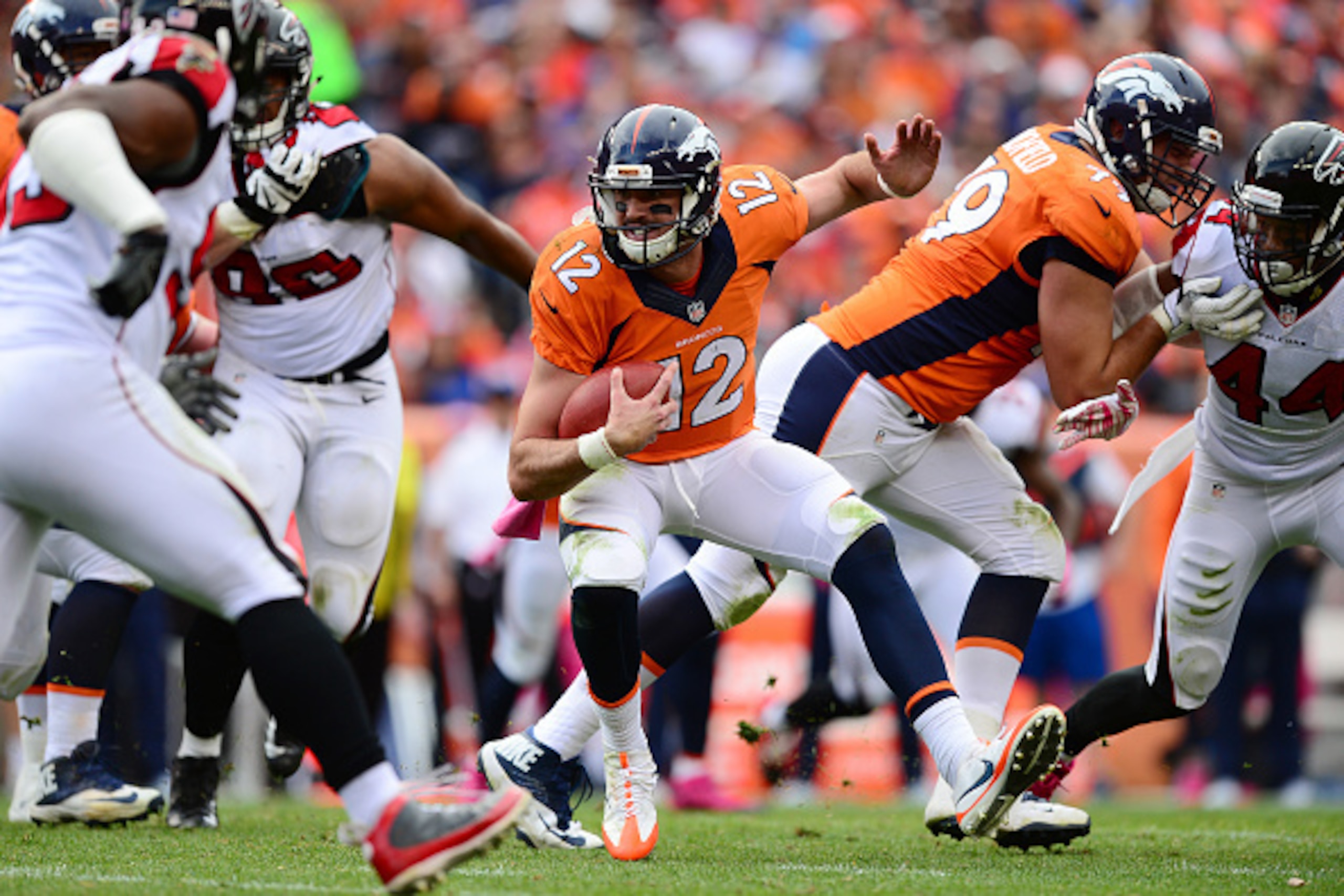DENVER, CO - OCTOBER 9:  Quarterback Paxton Lynch #12 of the Denver Broncos runs with ball but is unable to reach a first down in the second half of the game against the Atlanta Falcons at Sports Authority Field at Mile High on October 9, 2016 in Denver, 