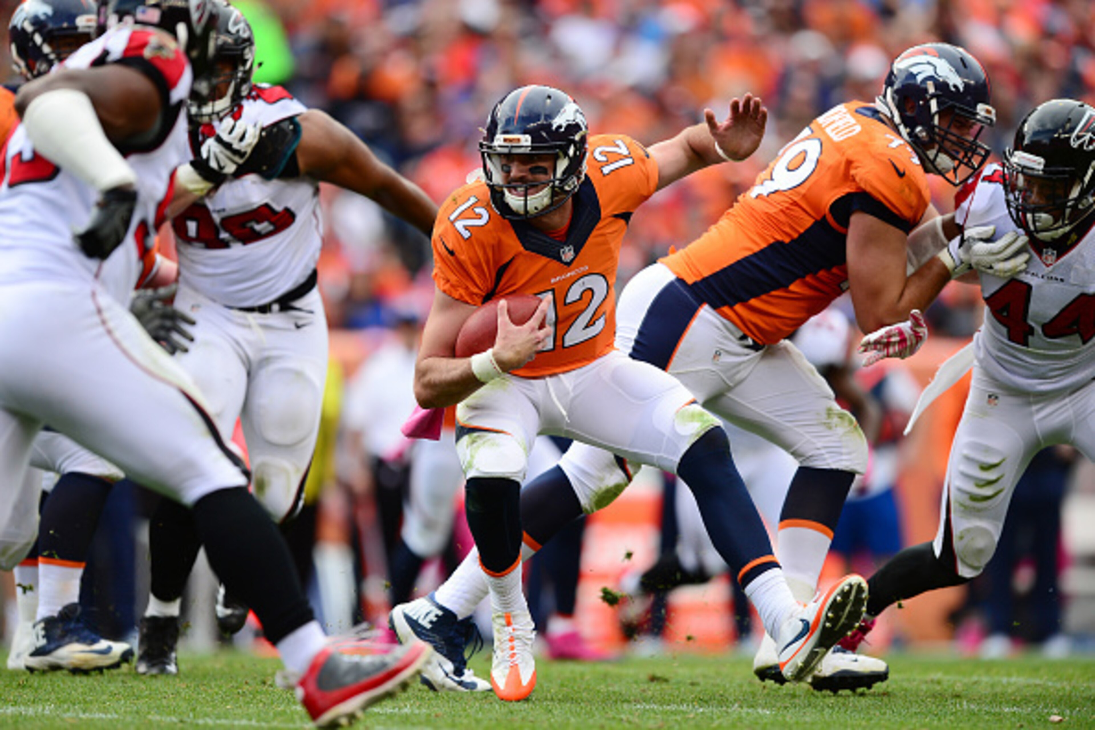 DENVER, CO - OCTOBER 9:  Quarterback Paxton Lynch #12 of the Denver Broncos runs with ball but is unable to reach a first down in the second half of the game against the Atlanta Falcons at Sports Authority Field at Mile High on October 9, 2016 in Denver, 