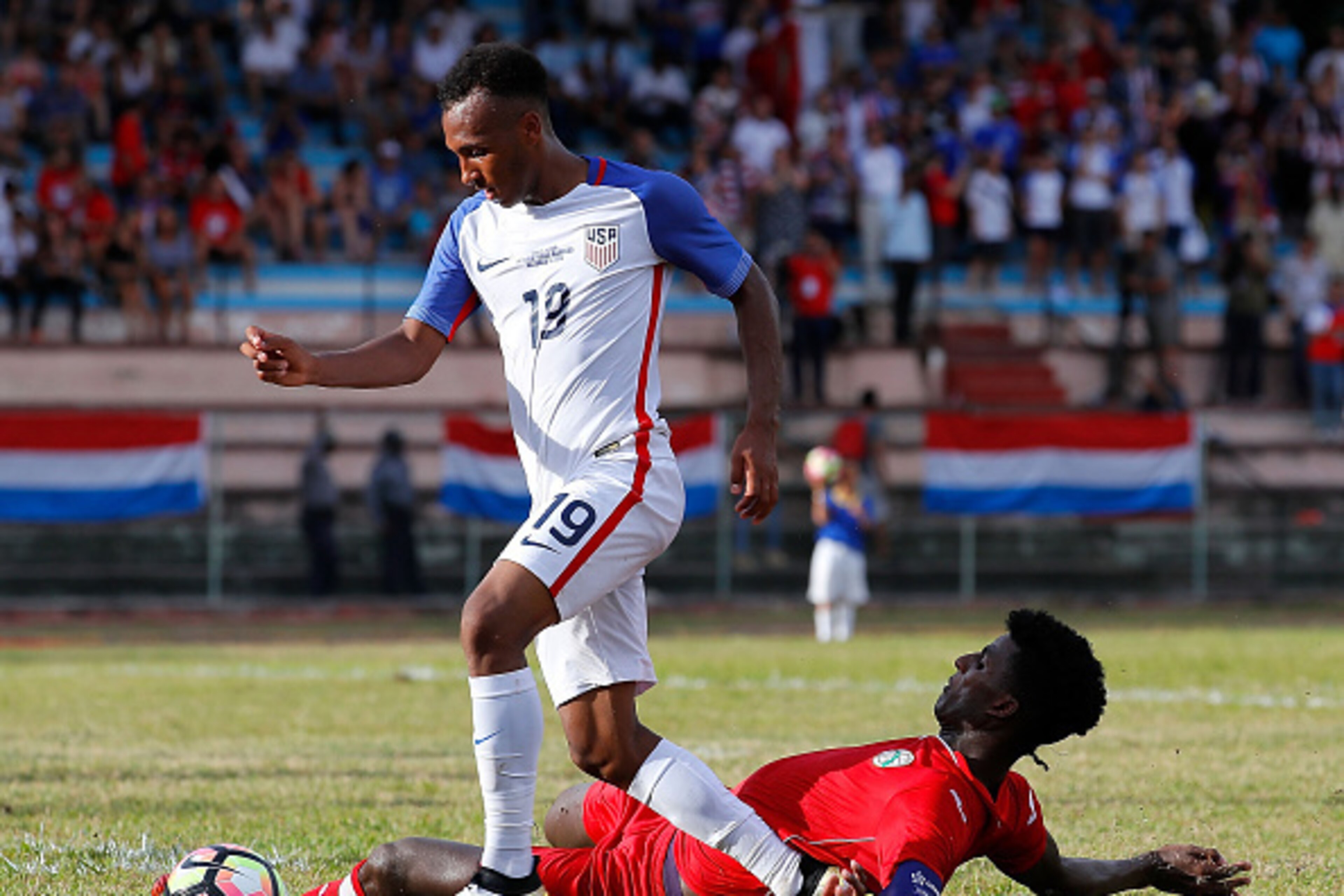 HAVANA, CUBA - OCTOBER 07:  Daniel Ernesto Luis Saez #6 of Cuba attempts to tackle Julian Green #19 of the United States at Estadio Pedro Marrero on October 7, 2016 in Havana, Cuba.  (Photo by Kevin C. Cox/Getty Images)