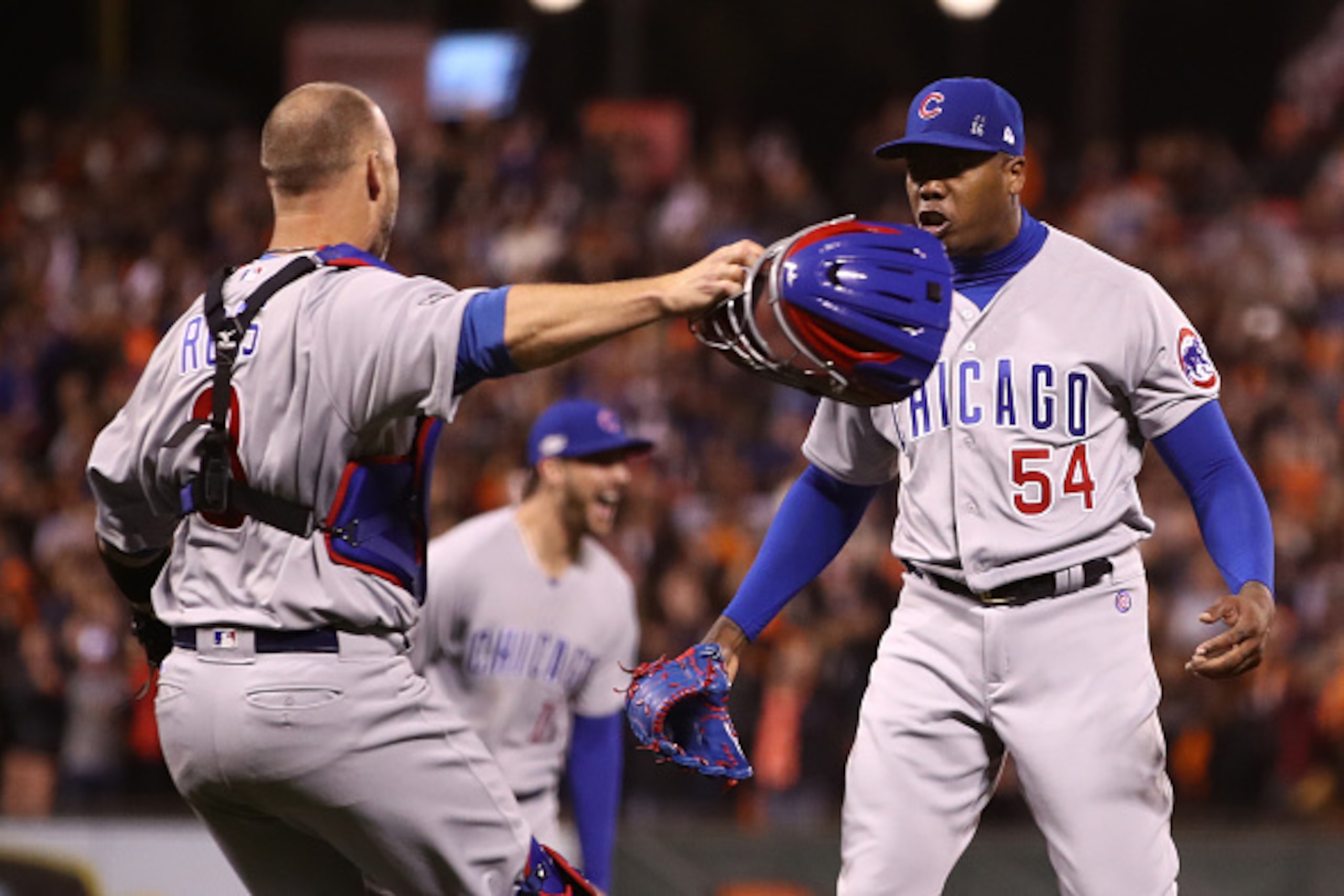 SAN FRANCISCO, CA - OCTOBER 11:  David Ross #3 and Aroldis Chapman #54 of the Chicago Cubs celebrate after defeating the San Francisco Giants 6-5 in Game Four of their National League Division Series to advance to the National League Championship Series a