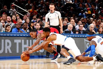 NEW YORK, NY - OCTOBER 10: Chasson Randle #4 of the New York Knicks and Bradley Beal #3 of the Washington Wizards dive for the ball during a preseason game on October 10, 2016 at Madison Square Garden in New York City, New York.  NOTE TO USER: User expres