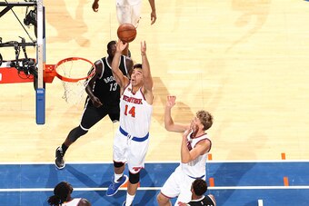 NEW YORK, NY - OCTOBER 8:  Willy Hernangomez #14 of the New York Knicks grabs the rebound Brooklyn Nets at Madison Square Garden in New York City on October 8, 2016.  NOTE TO USER: User expressly acknowledges and agrees that, by downloading and or using t