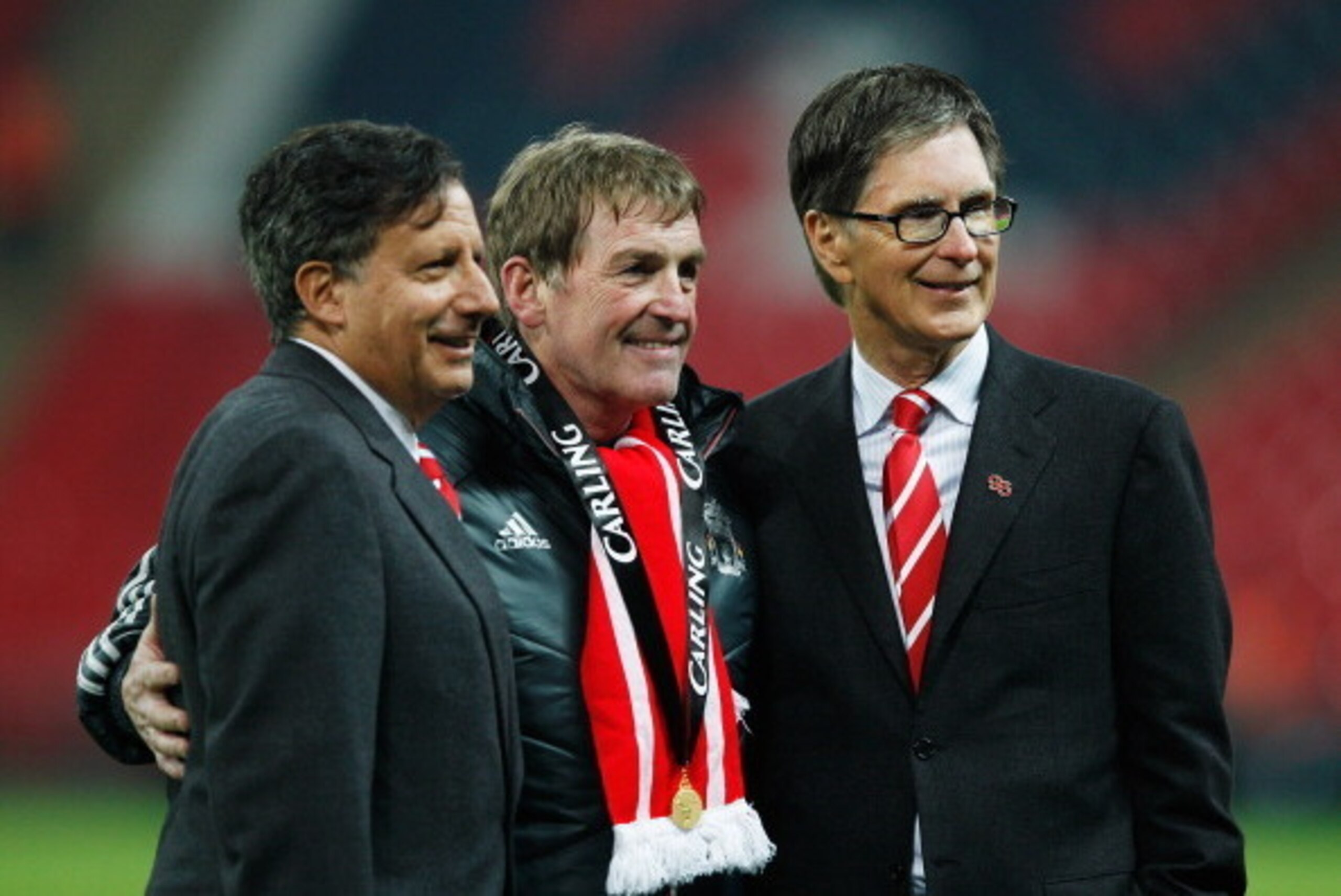 LONDON, ENGLAND - FEBRUARY 26:  Kenny Dalglish manager of Liverpool celebrates with Liverpool owners Liverpool owner Tom Werner (L) and John W Henry (R) after victory in the Carling Cup Final match between Liverpool and Cardiff City at Wembley Stadium on 