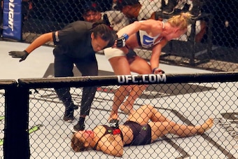 MELBOURNE, AUSTRALIA - NOVEMBER 15:  Referee Herb Dean ends the fight as New UFC women's bantamweight champion Holly Holm of the United States starts to celebrate her victory over Ronda Rousey of the United States in their UFC women's bantamweight champio