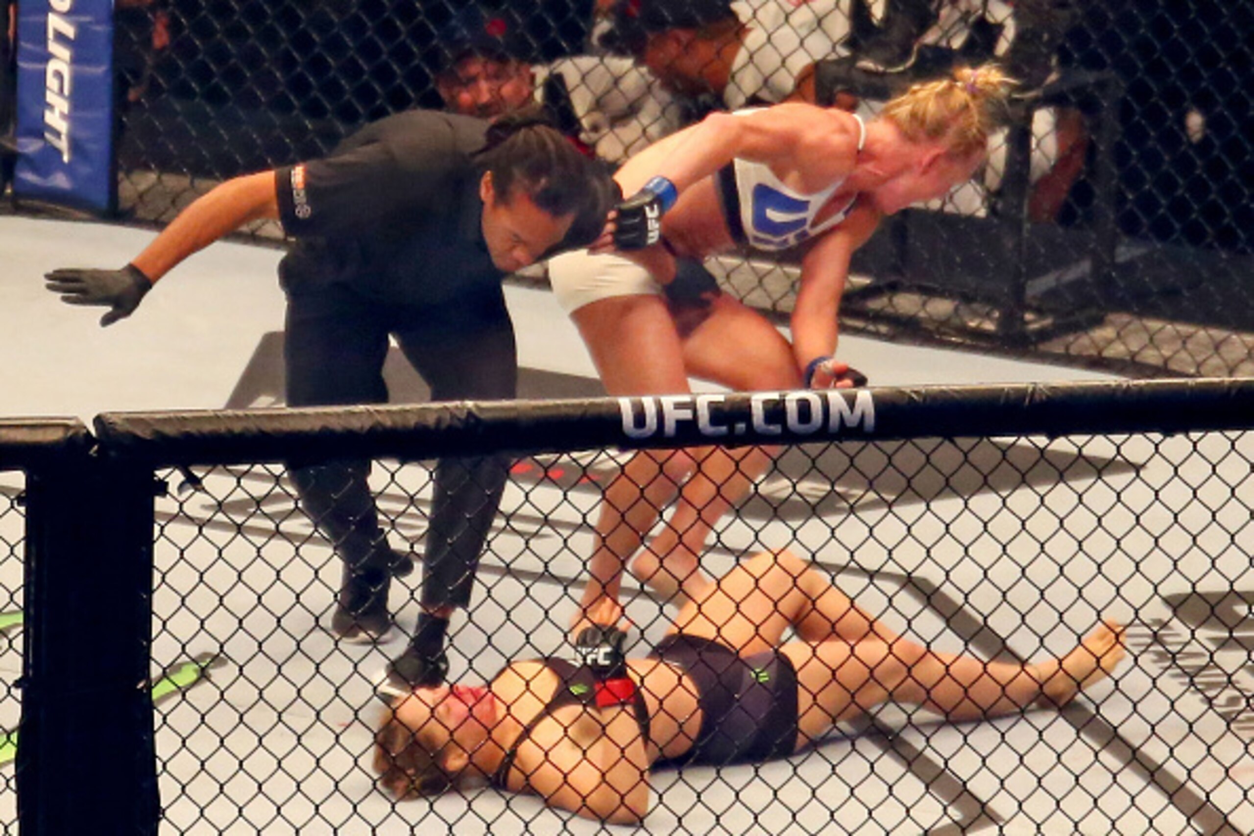 MELBOURNE, AUSTRALIA - NOVEMBER 15:  Referee Herb Dean ends the fight as New UFC women's bantamweight champion Holly Holm of the United States starts to celebrate her victory over Ronda Rousey of the United States in their UFC women's bantamweight champio