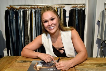 LAS VEGAS, NV - AUGUST 15:  Buffalo David Bitton Brand Ambassador Ronda Rousey signs an autograph at the Buffalo David Bitton booth during Project Vegas at the Mandalay Bay Convention Center on August 15, 2016 in Las Vegas, Nevada.  (Photo by David Becker
