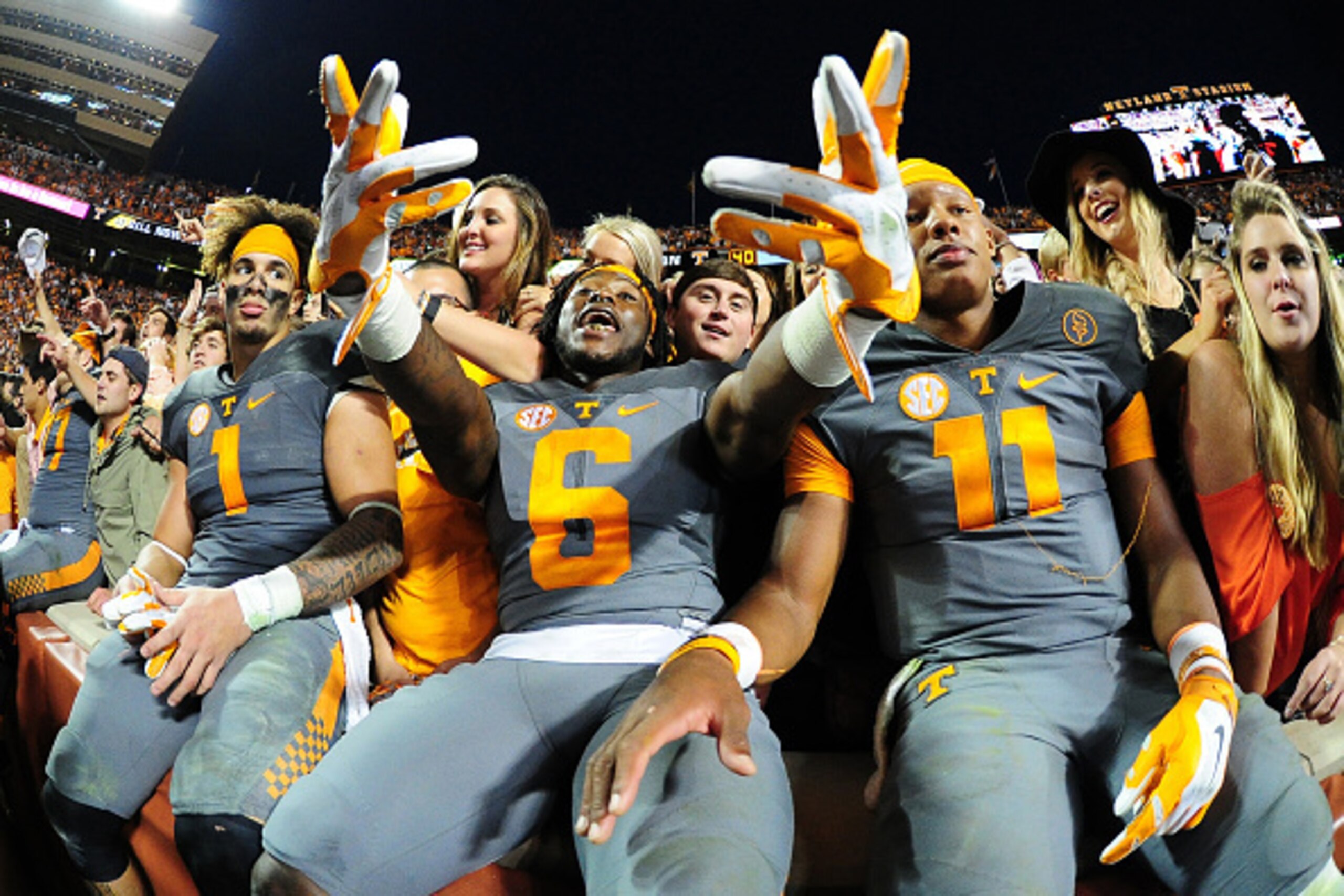 KNOXVILLE, TN - OCTOBER 10: Jalen Hurd #1, Alvin Kamara #6, and Joshua Dobbs #11 of the Tennessee Volunteers celebrate with fans after the game against the Georgia Bulldogs on October 10, 2015 at Neyland Stadium in Knoxville, Tennessee. (Photo by Scott Cu