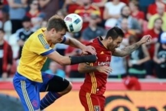 Aug 26, 2016; Sandy, UT, USA;  Colorado Rapids defender Axel Sjoberg (44) heads the ball away from Real Salt Lake forward Juan Martinez (7) during the second half at Rio Tinto Stadium. Real Salt Lake won the game 2-1 and also the Rocky Mountain Cup. Manda